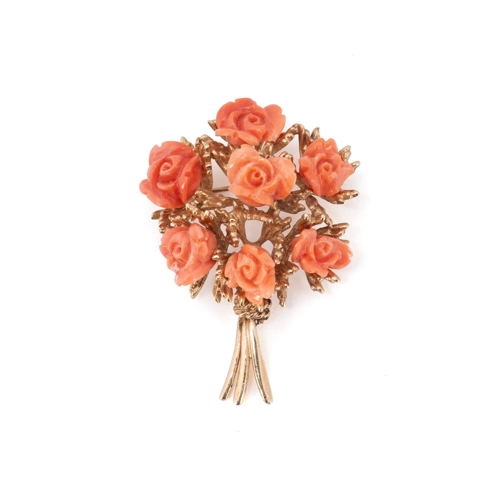 CORAL & GOLD FLORAL BROOCH: CORAL & GOLD FLORAL BROOCH A 14k yellow gold brooch with bouquet of carved coral roses. 20.6 grams