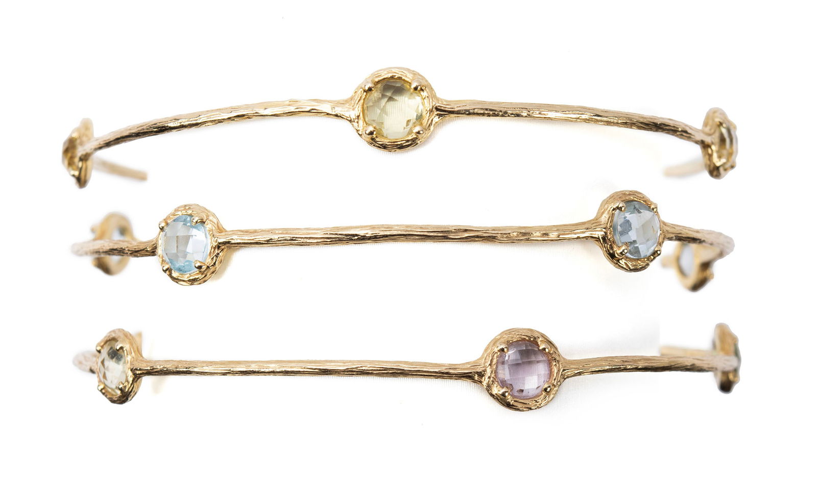 HERCO TRIO OF GOLD MULTI-COLORED STONE BANGLES: HERCO TRIO OF GOLD MULTI-COLORED STONE BANGLES Three (3) 14k yellow gold bangle bracelets with bezel set gemstones measuring approximately 5mm each. Hallmarked. Diameter: 3 in. (7.6 cm.); Total