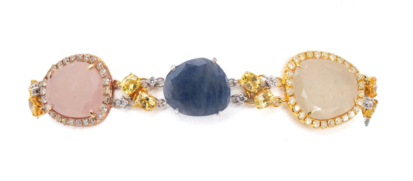 MULTI-STONE GOLD BRACELET: MULTI-STONE GOLD BRACELET An 18k yellow gold bracelet with quartz stones surrounded by round brilliant cut diamonds. Length: 7 3/4 in. (19.7 cm.); 22 grams
