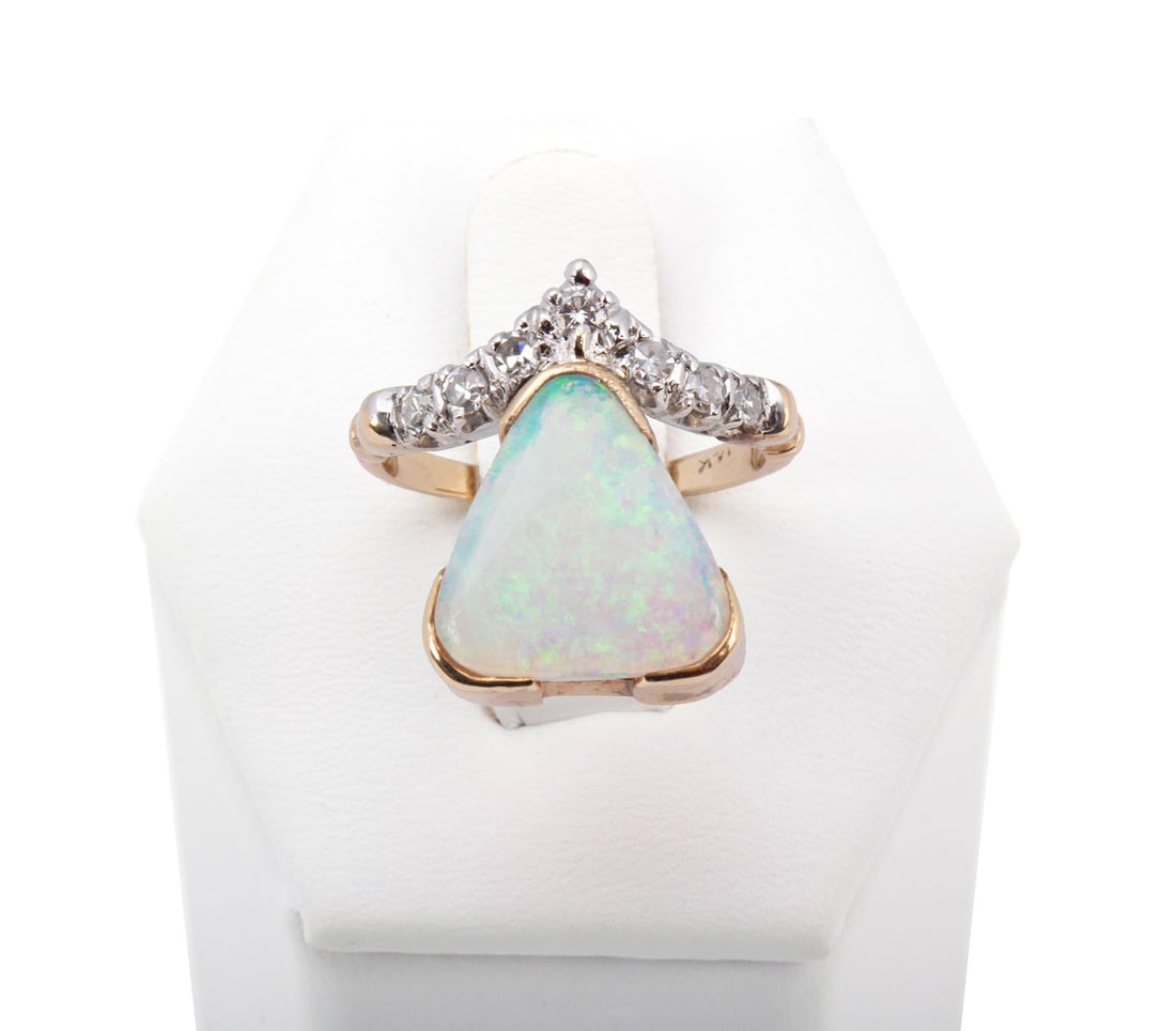 OPAL & DIAMOND GOLD RING: OPAL & DIAMOND GOLD RING A 14k yellow gold ring set with one (1) triangular cabochon cut opal measuring 12mm x 13.3mm with six (6) round cut single cut diamonds and one (1) round brilliant cut