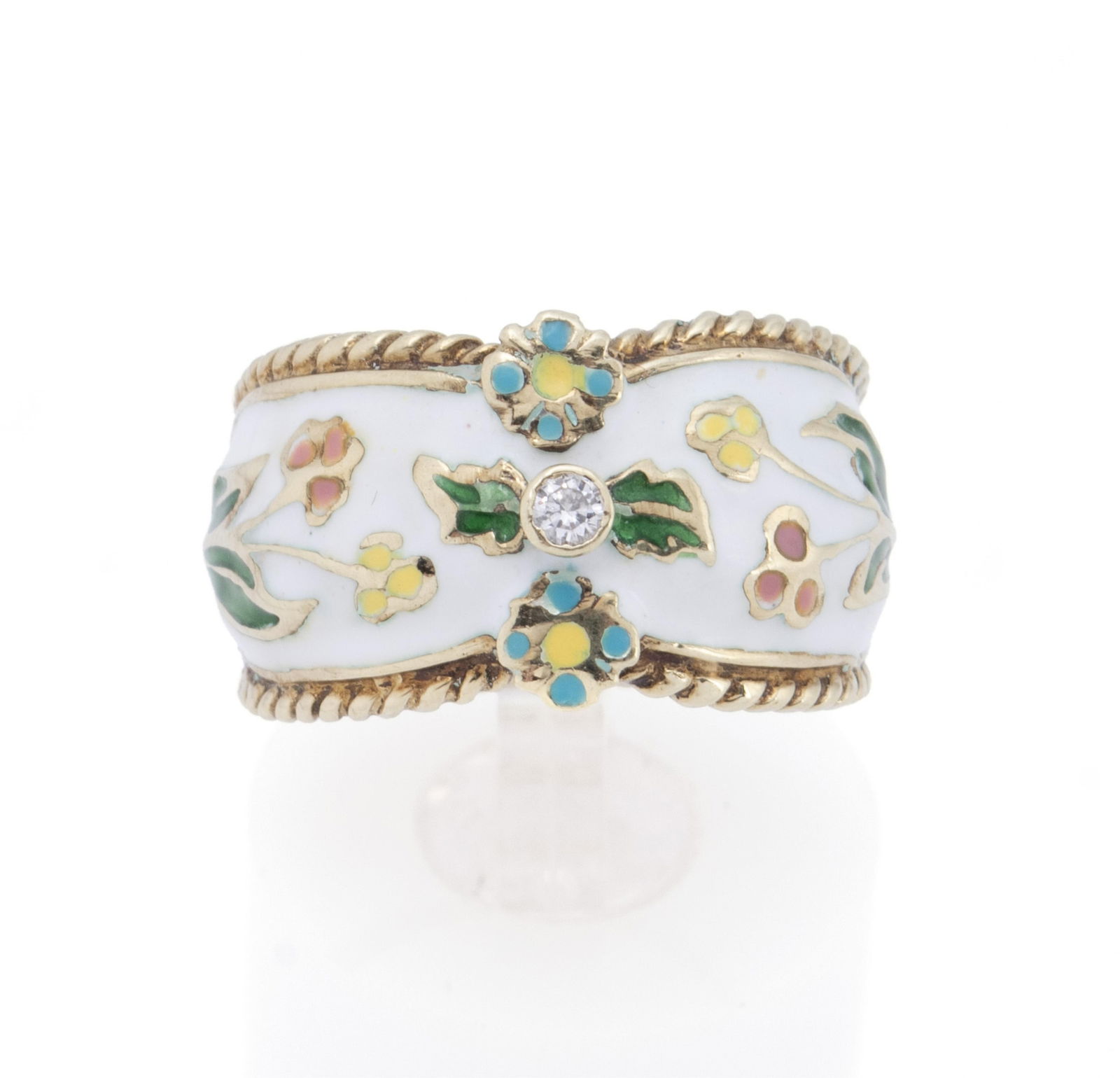 ENAMEL GOLD DIAMOND RING: ENAMEL GOLD DIAMOND RING A 14k yellow gold ring with floral decorated enamel and bezel set with one (1) round brilliant cut diamond weighing approximately 0.04ct. Hallmarked. Size 6.5; 10 grams