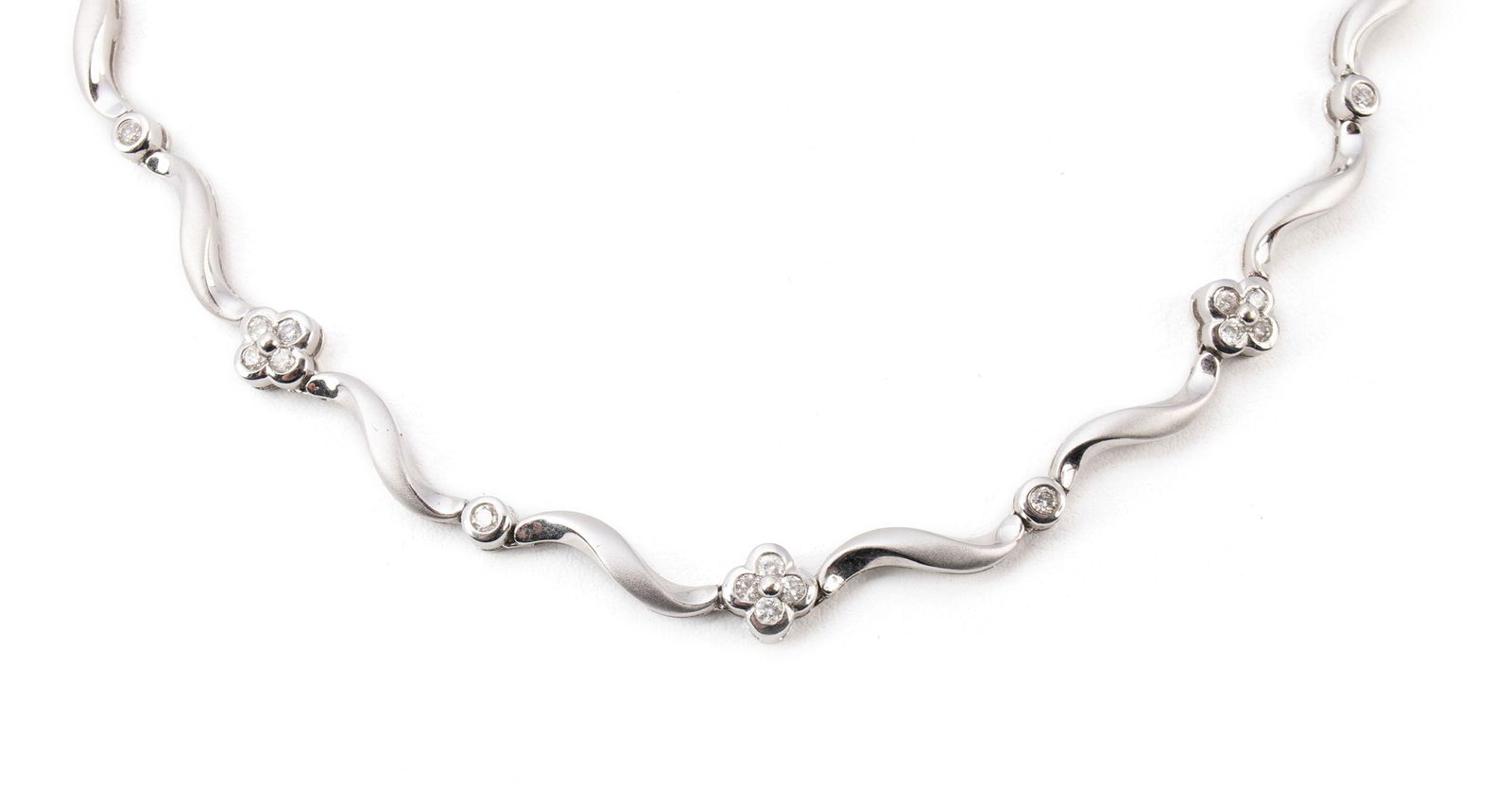 DIAMOND WHITE GOLD NECKLACE: DIAMOND WHITE GOLD NECKLACE A 14k white gold necklace with alternating diamond set and gold swirl links. Necklace has twenty-six (26) round brilliant cut diamonds weighing approximately 0.03ct. each.