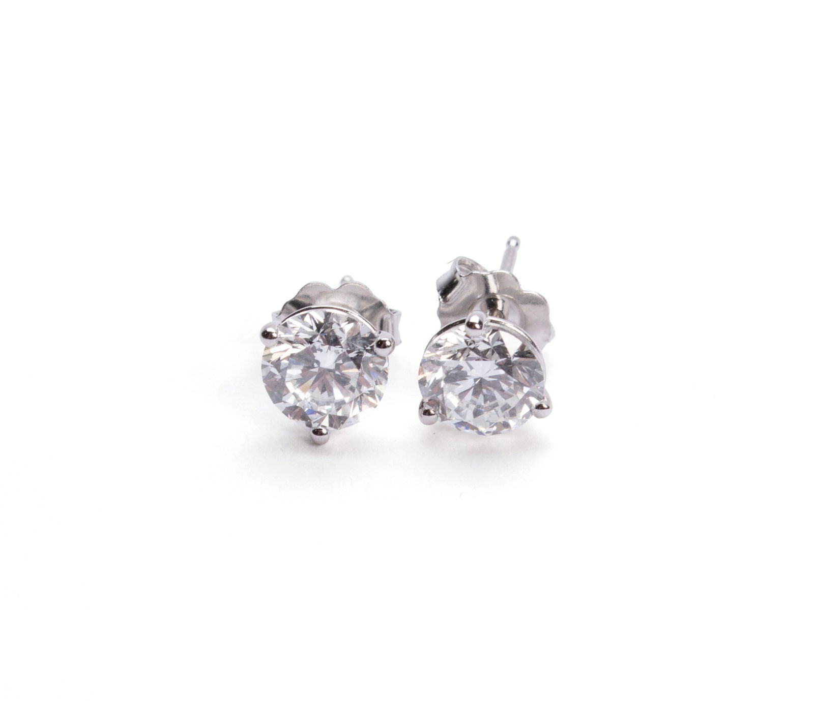 DIAMOND STUD EARRINGS: DIAMOND STUD EARRINGS A pair of 14k white gold three prong martini style pierced earrings set with two (2) round brilliant cut Lab Grown diamonds weighing 2.00ctw. Approximate color and clarity FG VS