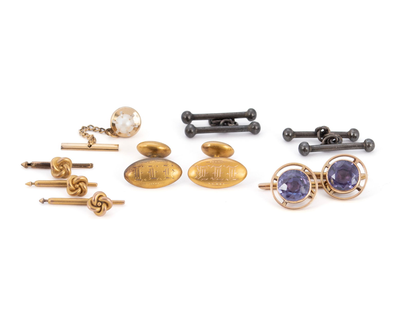 MENS CUFFLINKS COLLECTION: MENS CUFFLINKS COLLECTION One (1) pair of 18k gold with alexandrite stones to center (8 grams, hallmarked), along with two (2) additional pairs, three (3) tuxedo buttons, and a pearl tie tack.