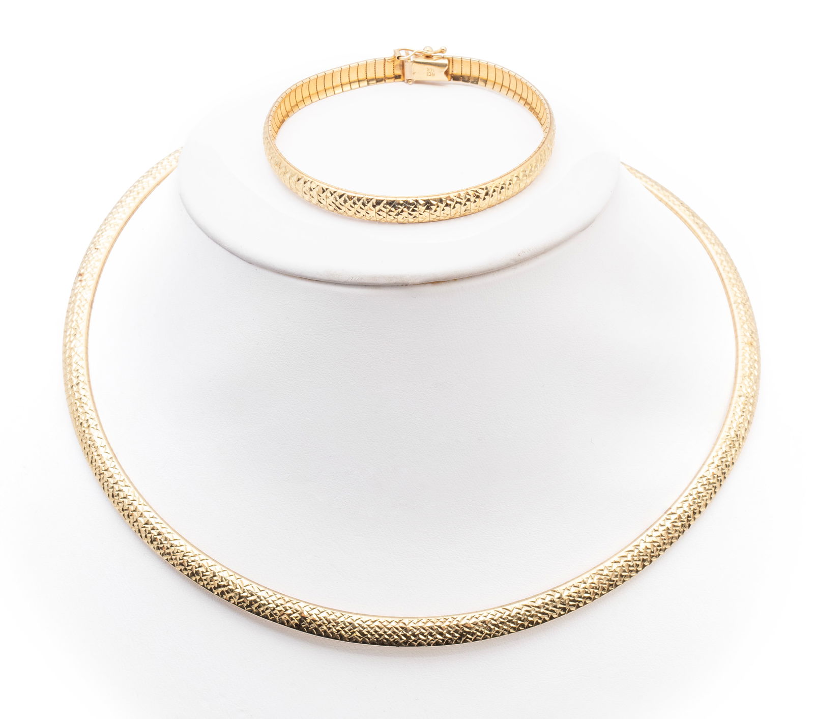 YELLOW GOLD OMEGA NECKLACE AND BRACELET SET: YELLOW GOLD OMEGA NECKLACE AND BRACELET SET A 14k yellow gold diamond cut Omega neck chain with a complimentary 14k yellow gold diamond cut Omega bracelet. Bracelet length: 7 1/4 in. (18.4 cm.); 43