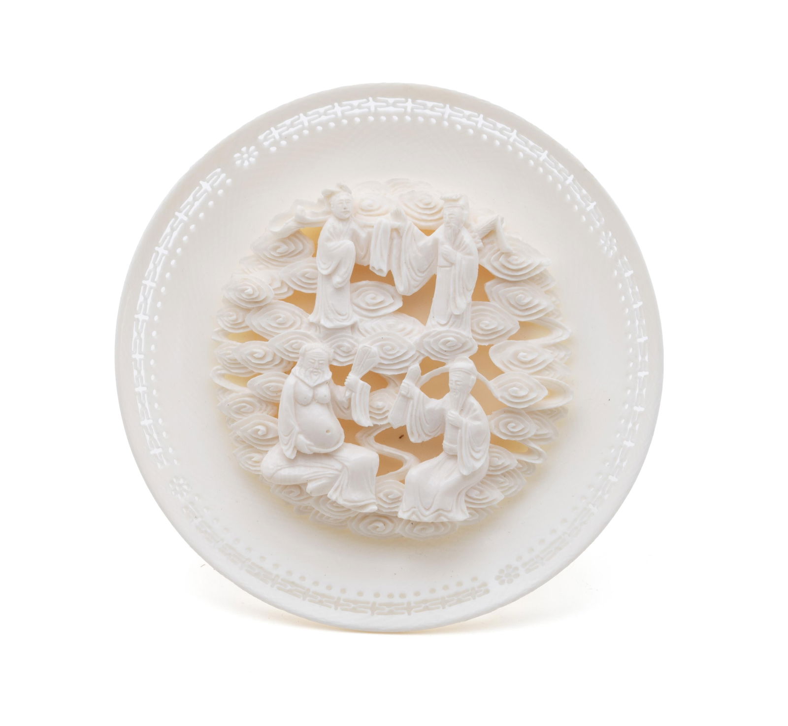 CHINESE CIRCULAR FIGURAL CARVING: CHINESE CIRCULAR FIGURAL CARVING Chinese, early 20th century. Finely carved group of four figures floating in the clouds, on a concave celluloid mount with pierced design around the edge. Diameter: 4