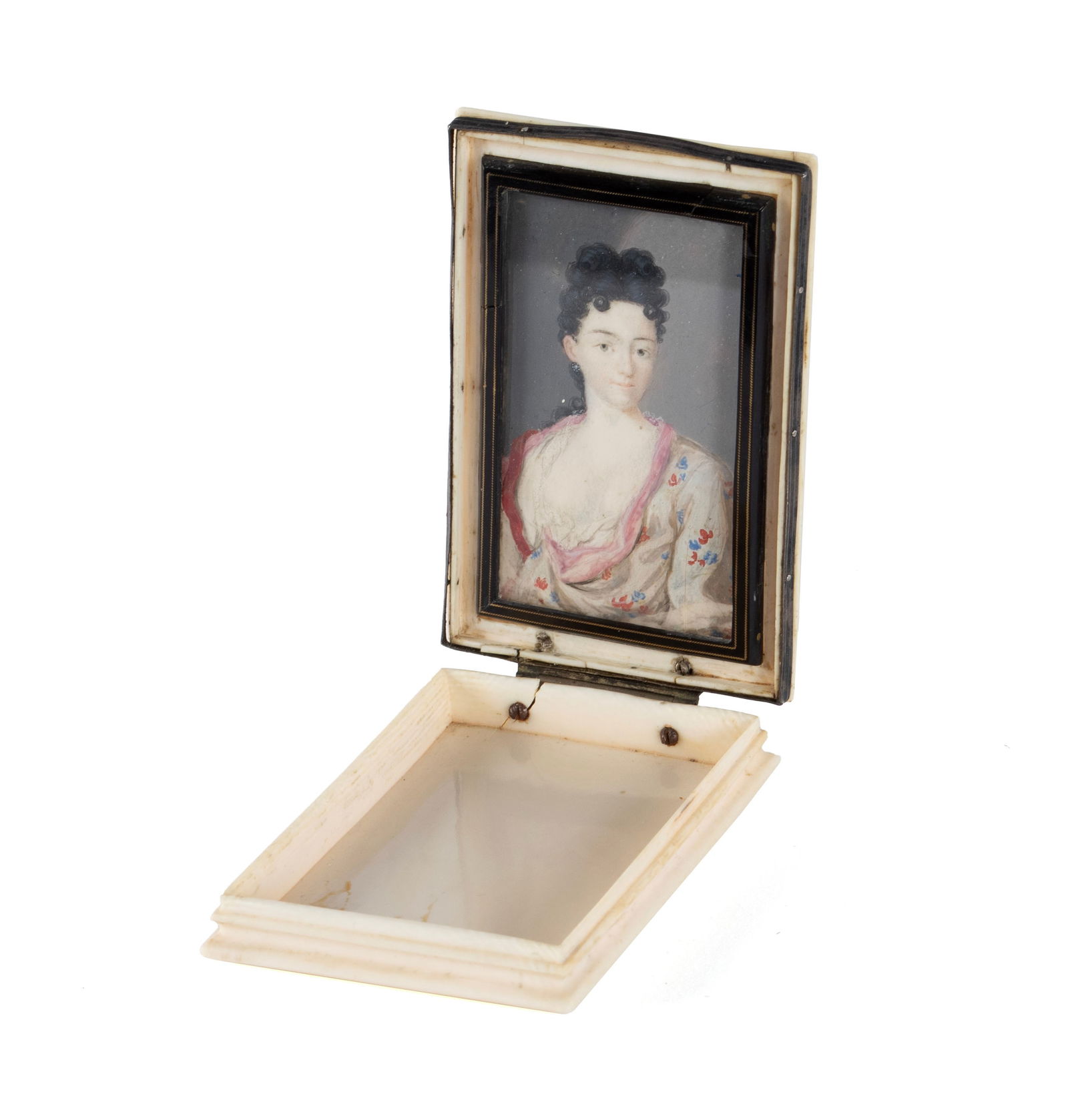 MINIATURE CASED PORTRAIT OF A WOMAN: MINIATURE CASED PORTRAIT OF A WOMAN Continental, 18th/19th century. Half-length portrait of a beauty with black hair and floral dress, held in a decorative hinged case. Portrait: 2 5/8 x 1 1/2 in.