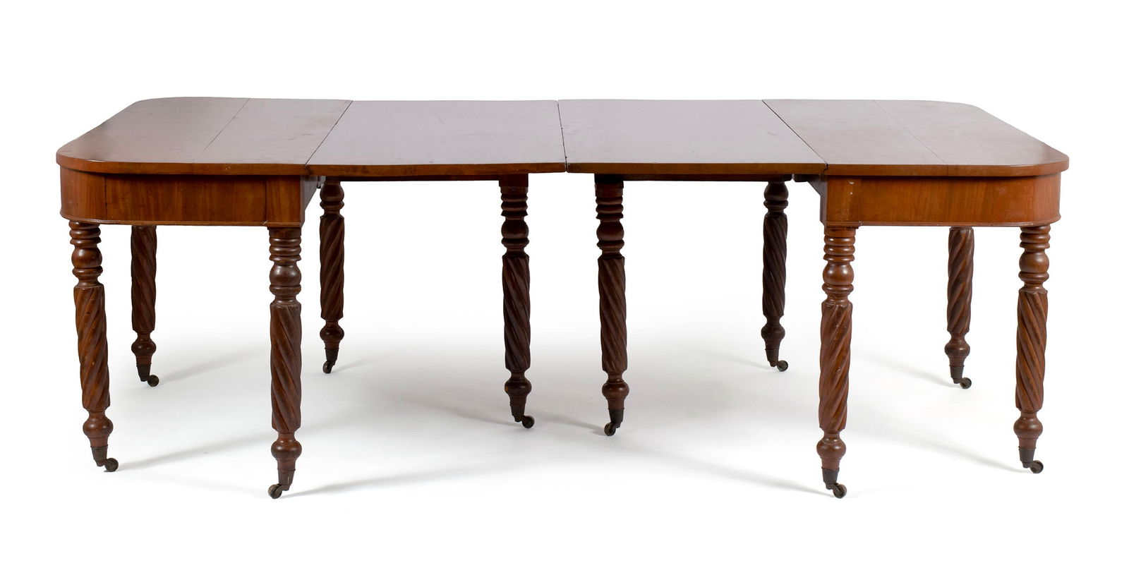 CLASSICAL BANQUET TABLE: CLASSICAL BANQUET TABLE American, 19th century, cherry and mahogany. Each part with a "D" form surface and large drop leaf to one side, on ring turned and spiraling legs with casters. Total length is
