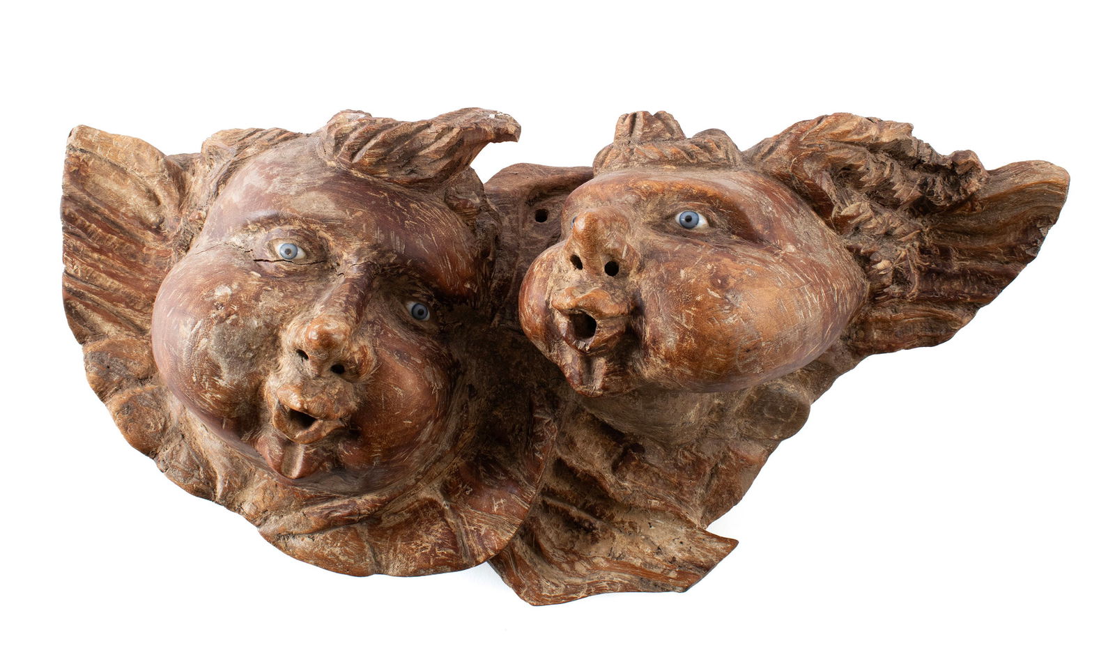 BAROQUE STYLE CARVING: BAROQUE STYLE CARVING 20th century. Two (2) blowing cherubs with glass eyes. 17 x 25 in. (43.2 x 63.5 cm.)