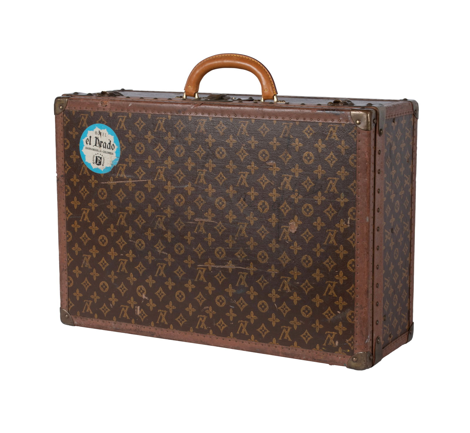 DESIGNER STYLE SUITCASE: DESIGNER STYLE SUITCASE 20th century. Canvas and leather suitcase with brass mounts and linen interior. Spurious labels/marks to interior and brass. 8 1/2 x 16 x 23 3/4 in. (21.6 x 40.6 x 60.3 cm.)