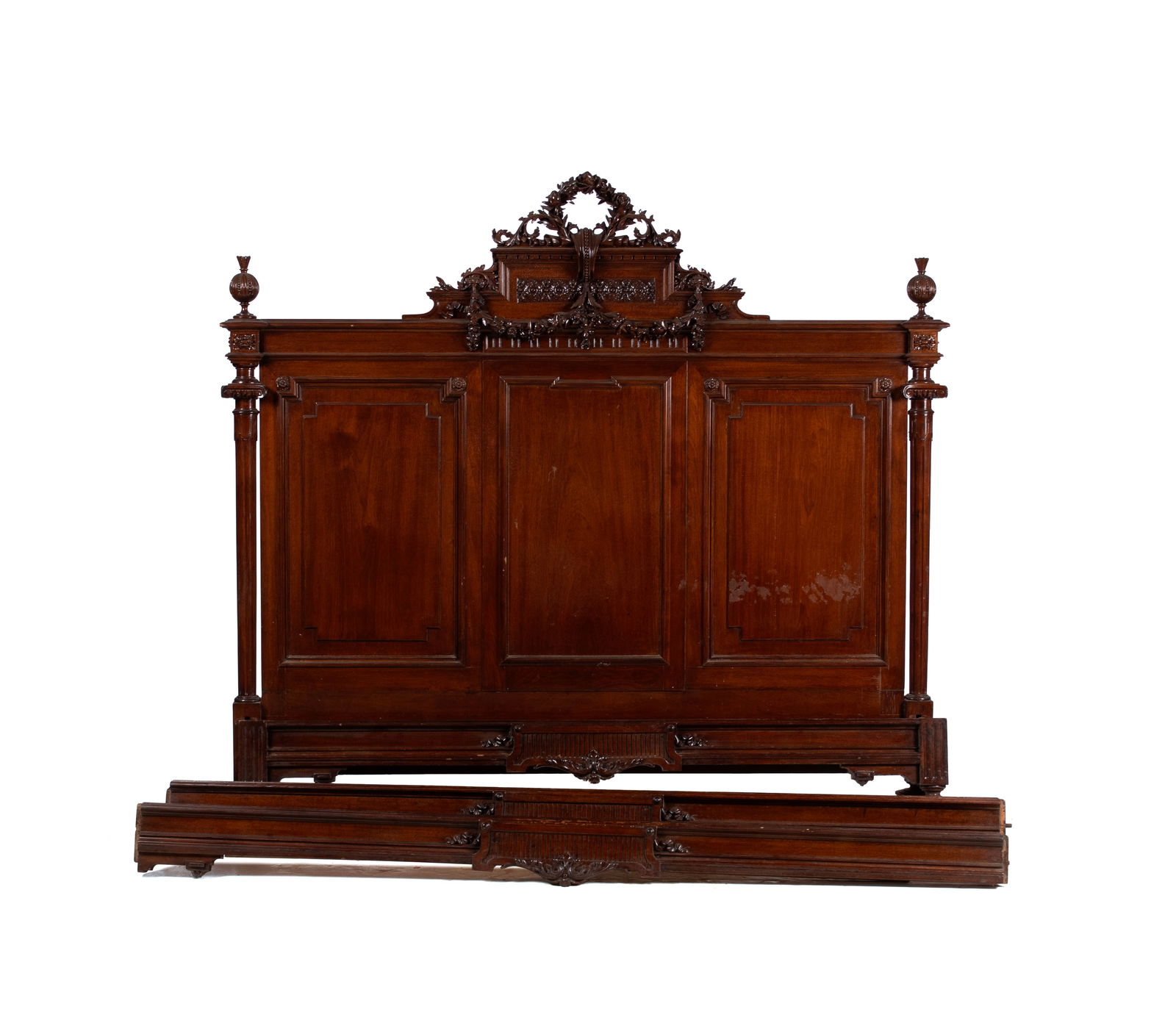 LOUIS XVI STYLE BEDSTEAD: LOUIS XVI STYLE BEDSTEAD Continental, late 19th century. Carved open wreath form crest above flowering festoons flanked by urn form finials to each side capping the tapering fluted pilasters, with