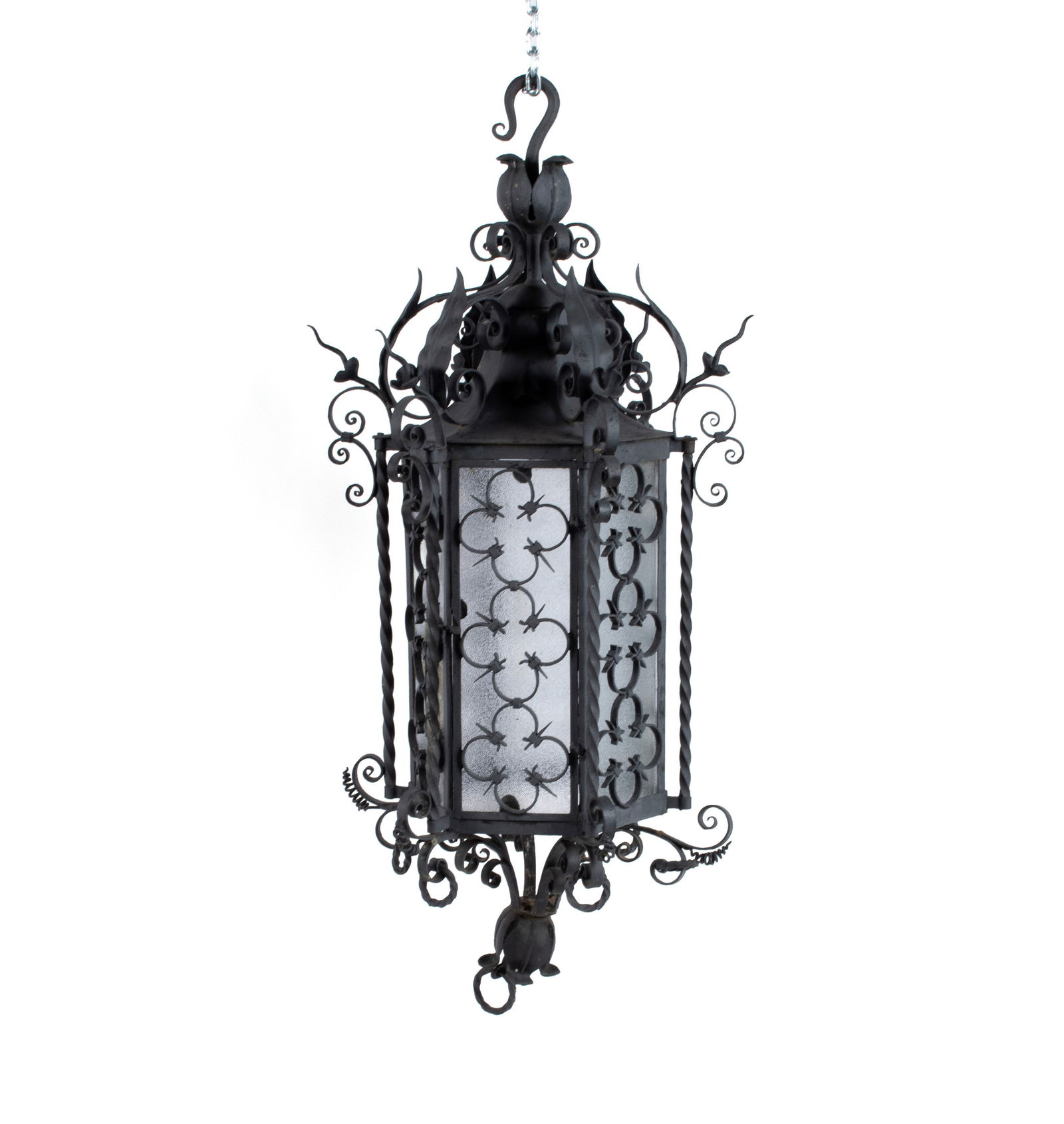 WROUGHT IRON HANGING LANTERN: WROUGHT IRON HANGING LANTERNAmerican, mid-20th century. Hexagonal lantern with allover scrolling highlights, clover form ornamentation to the six (6) side panels, and foliate metalwork to top and bott