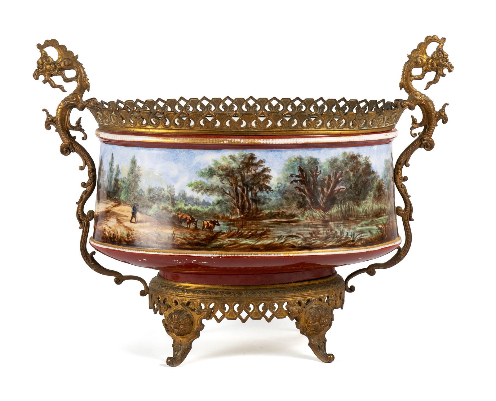 HAND PAINTED GILT METAL MOUNTED PORCELAIN CENTERPIECE: HAND PAINTED GILT METAL MOUNTED PORCELAIN CENTERPIECEContinental, circa 1874, signed "A. E. Stapleaux - P 1874". Large oval centerpiece painted all around with a summer scene of cattle watering in a s
