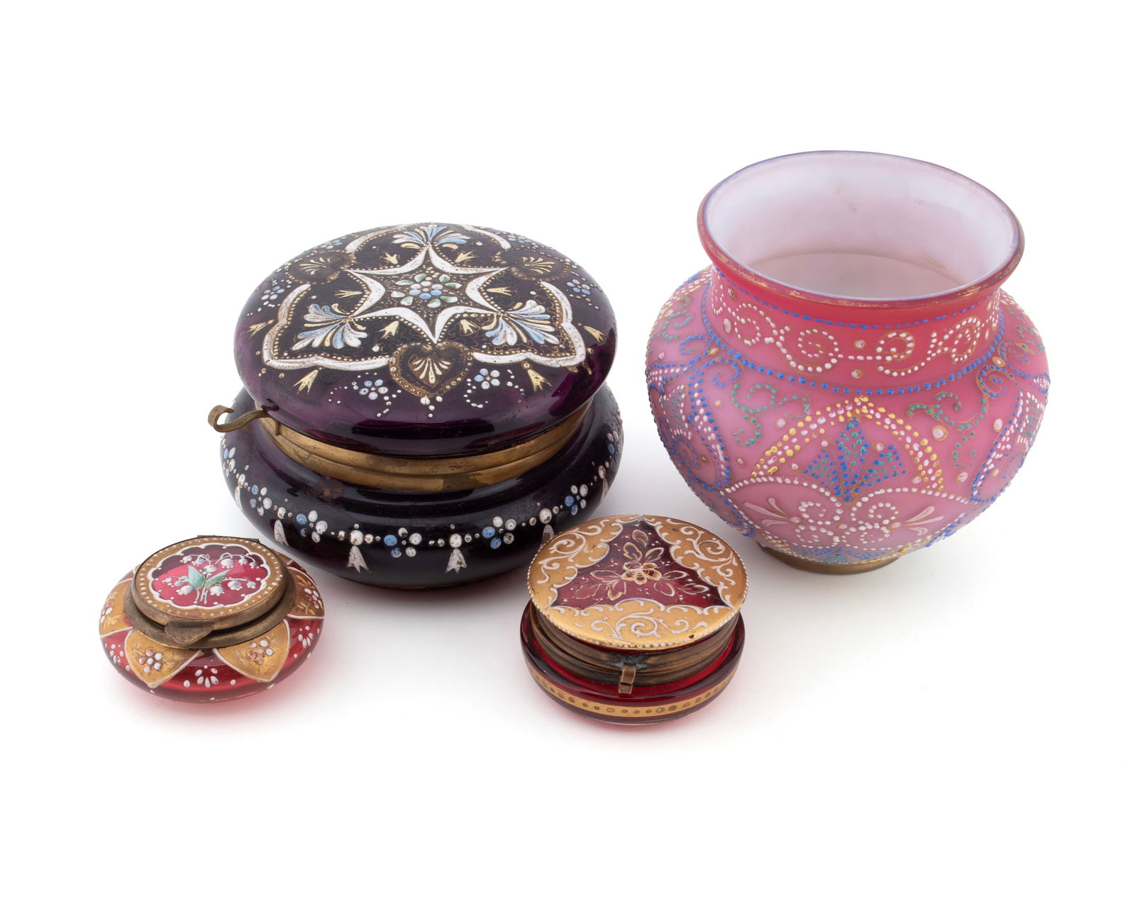 FOUR PIECES OF VICTORIAN DECORATIVE GLASSWARE: FOUR PIECES OF VICTORIAN DECORATIVE GLASSWARE American, 19th century. Pink over cased glass Mount Washington globular vase with intricate petite point design, together with three Moser style circular