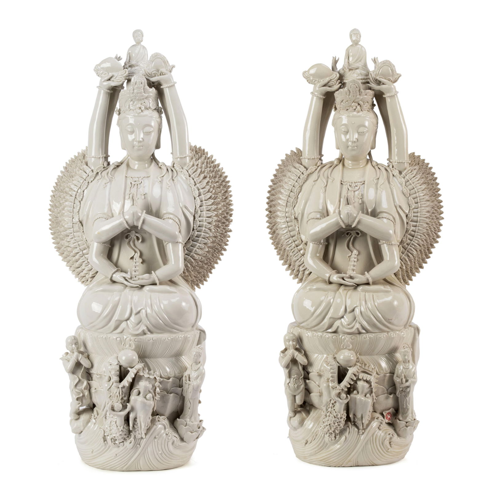 PAIR OF BLANC DE CHINE BODHISATTVA FIGURES: PAIR OF BLANC DE CHINE BODHISATTVA FIGURES Chinese, 20th century. Depicts Quan Yin, the goddess of compassion in the "thousand-arm" form showing her ability to help many at one time, with a figure