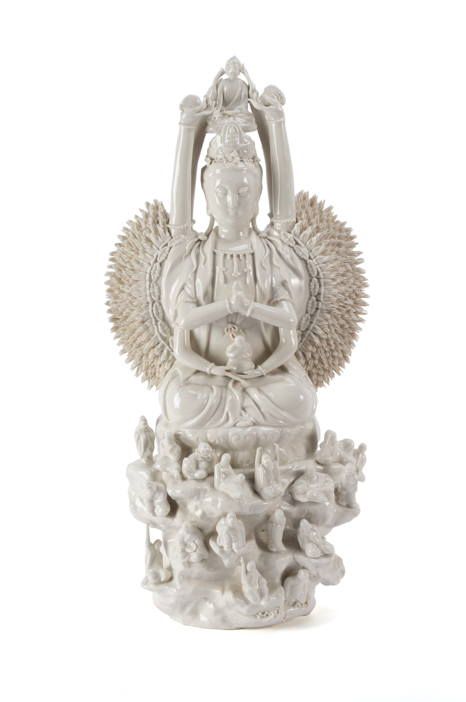BLANC DE CHINE BODHISATTVA: BLANC DE CHINE BODHISATTVA Chinese, 20th century. Depicts Quan Yin, the goddess of compassion in the thousand-arm form, with figures on her head, in her lap and low across the front. 24 x 12 in. (61