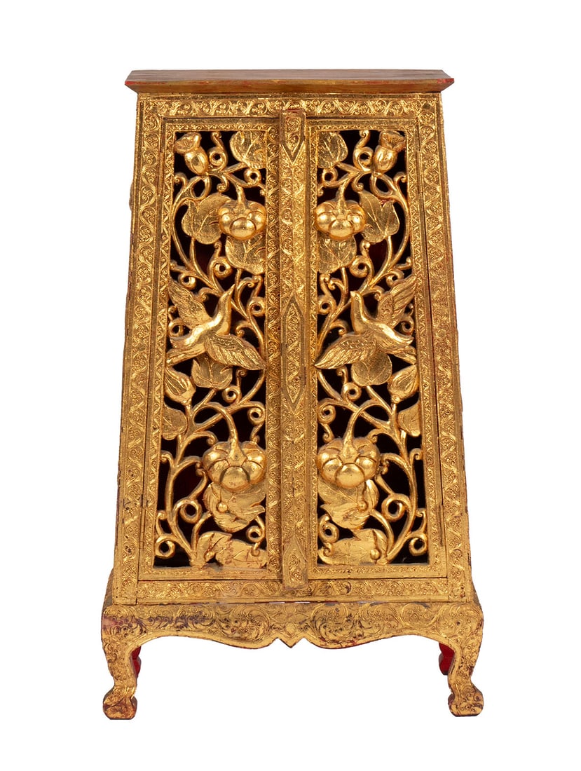 GOLD FINISHED SIDE CABINET: GOLD FINISHED SIDE CABINET Chinese, 20th century. Flat top to the tapering case with fully pierced carvings to the sides and doors to the front, all carved with scrolling vines with flowers and