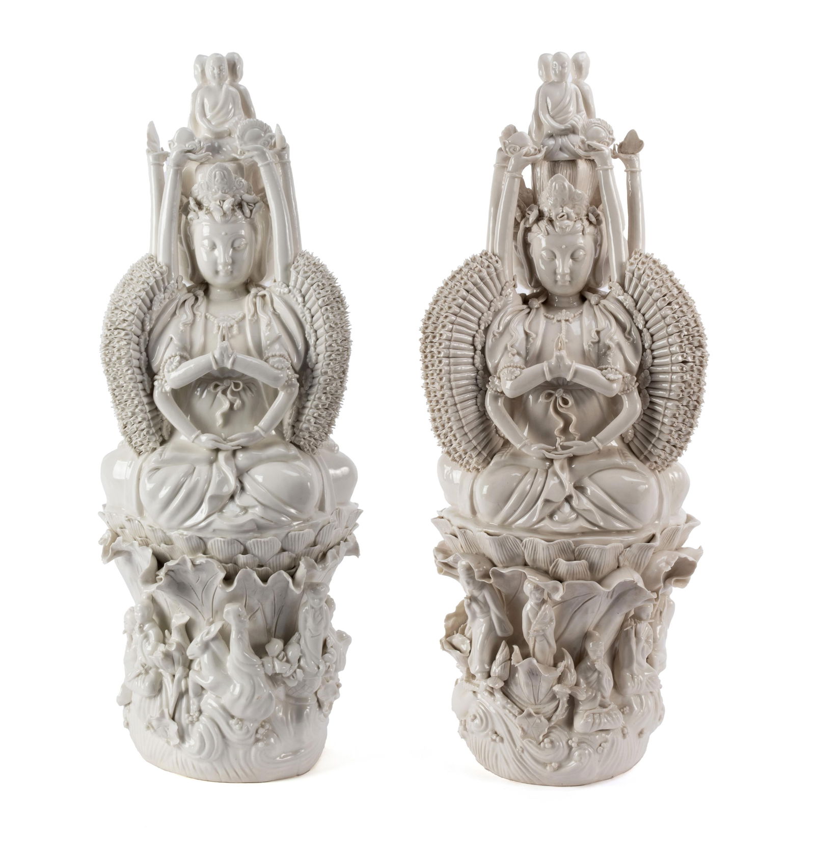 PAIR OF BLANC DE CHINE BODHISATTVA TRIPTYCH FIGURES: PAIR OF BLANC DE CHINE BODHISATTVA TRIPTYCH FIGURES Chinese, 20th century. Depicts Quan Yin, the goddess of compassion, in the thousand-arm form facing three directions, seated on a lotus flower with
