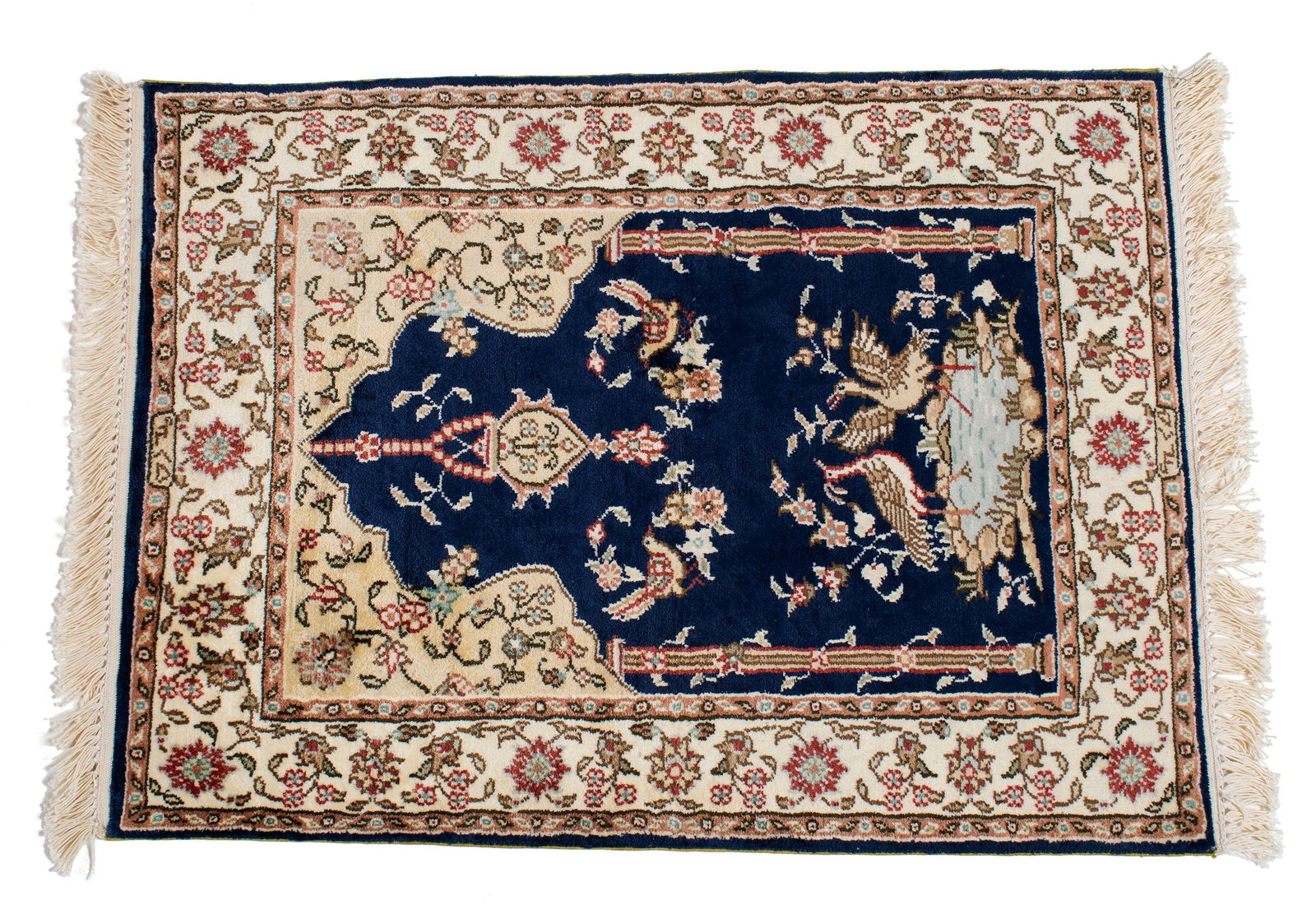 HEREKE SILK PRAYER RUG, SIGNED: HEREKE SILK PRAYER RUG, SIGNED Turkish, 20th century. Birds frolicking against the navy ground with chandelier hanging above and flowering vines to the upper corners, ivory border with guard borders,