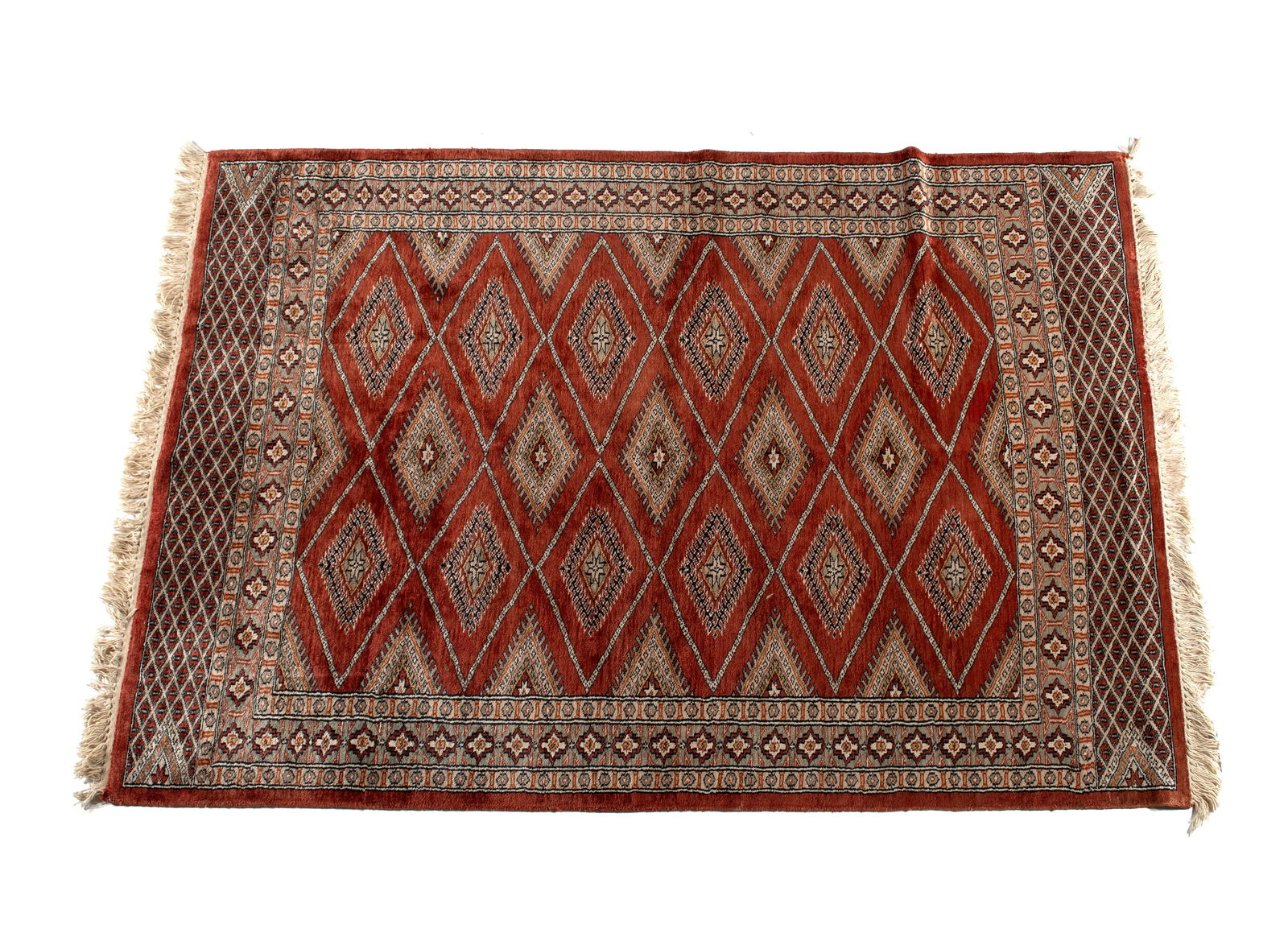BOKHARA AREA RUG: BOKHARA AREA RUG Indian, 20th century. Diamond form medallions on the orange/red field, grey border with guard borders showing geometric end panels at each end. 6 ft. 1 in. x 4 ft. 1 in.