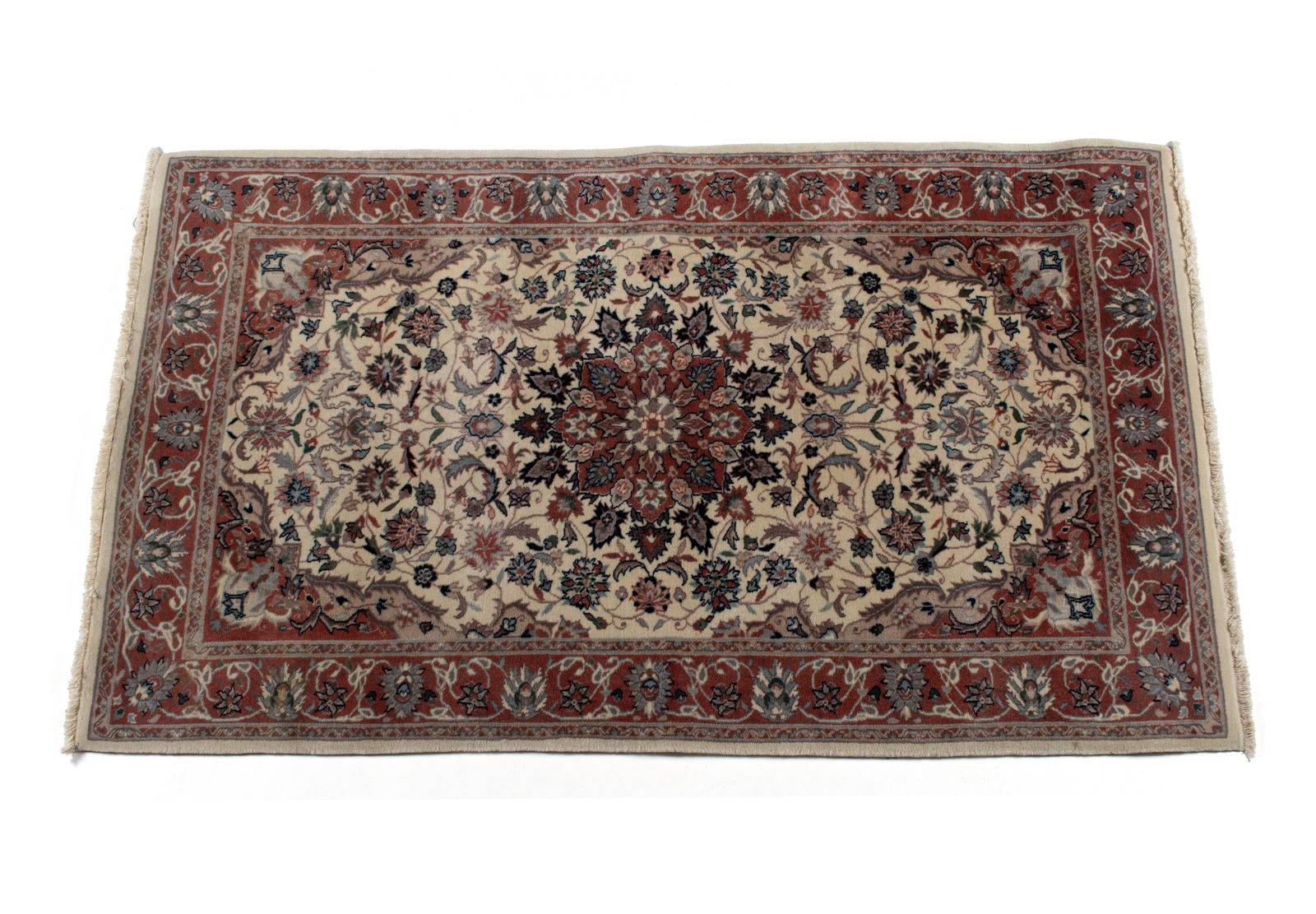 INDO-KASHAN AREA RUG: INDO-KASHAN AREA RUG Indian, 20th century. Rust colored foliate medallion centers the ivory field covered with spiraling foliate vines with matching rust corners, matching primary border with guard
