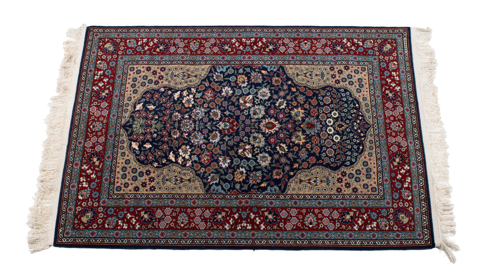 HEREKE AREA RUG: HEREKE AREA RUGTurkish, 20th century, signed "Hereke" near one corner. Floral design across the shaped navy field showing large floral decorated beige corners, red border with multiple guard borders.5