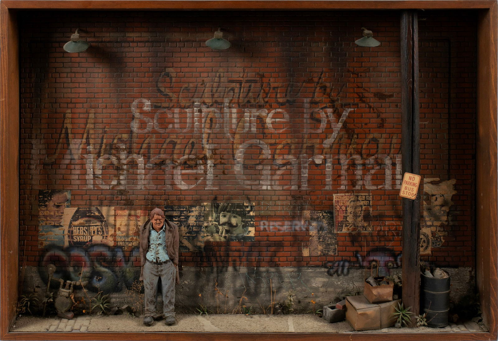 MICHAEL GARMAN (AMERICAN, B. 1938): Michael GarmanAmerican, b. 1938Mixed media dioramaSigned across brick wall. Lighted diorama of a man in a graffiti-filled alley.30 x 44 x 5 1/2 in. (76.2 x 111.8 x 14 cm.) Acquired from the artist and