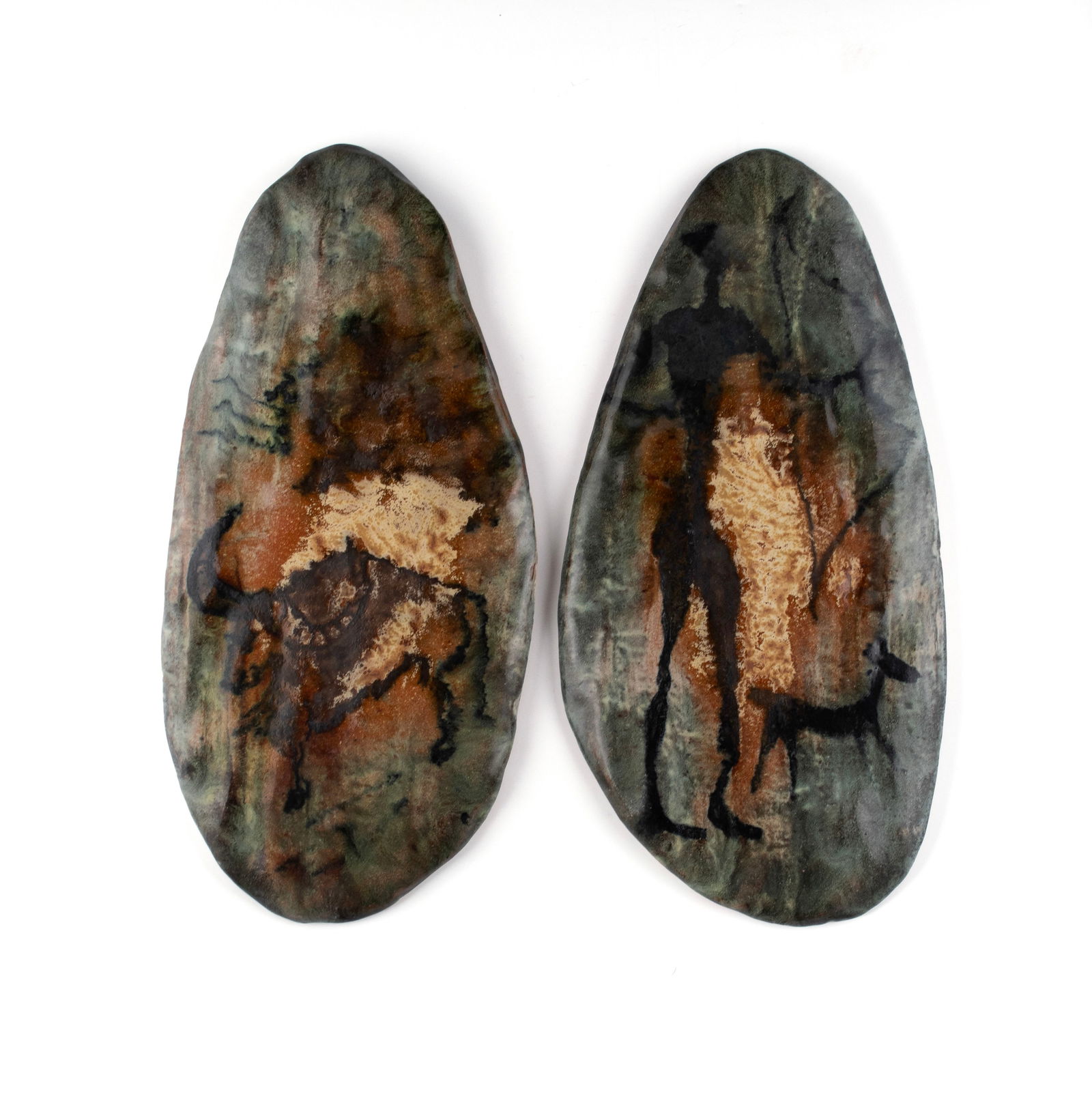 PAIR OF TERRACOTTA WALL HANGINGS: PAIR OF TERRACOTTA WALL HANGINGSContinental, mid-20th century. Two glazed terracotta freeform oval panels, one (1) painted with a bull, the other with a huntress, unmarked.Each: 12 3/4 x 6 in. (32.4 x