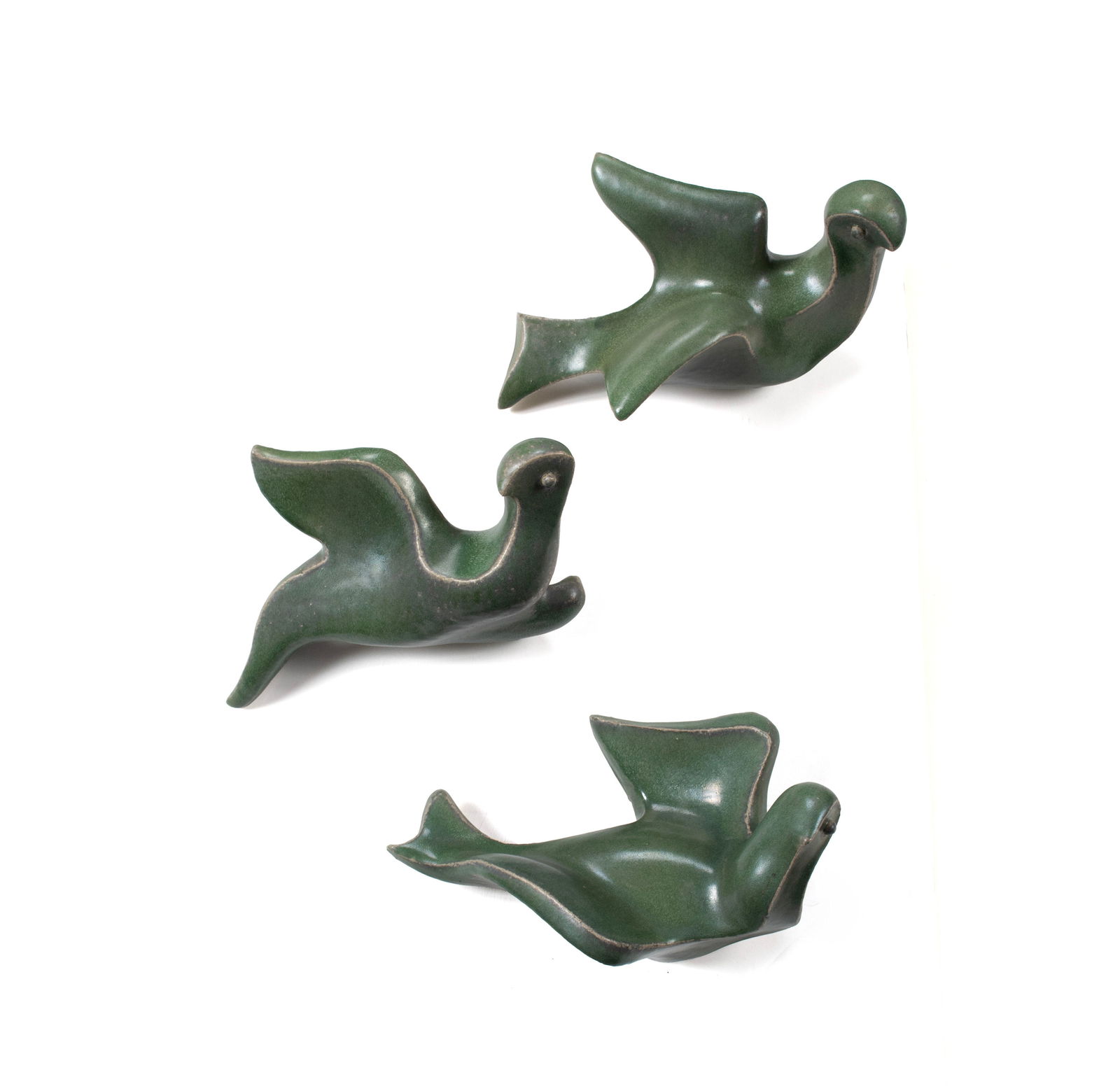 (NEWELL) HILLIS ARNOLD (AMERICAN, 1906-1988): (Newell) Hillis ArnoldAmerican, 1906-1988CeramicUnsigned. Three (3) green glazed doves, for wall mounting.Largest: 11 x 5 x 5 in. (27.9 x 12.7 x 12.7 cm.)