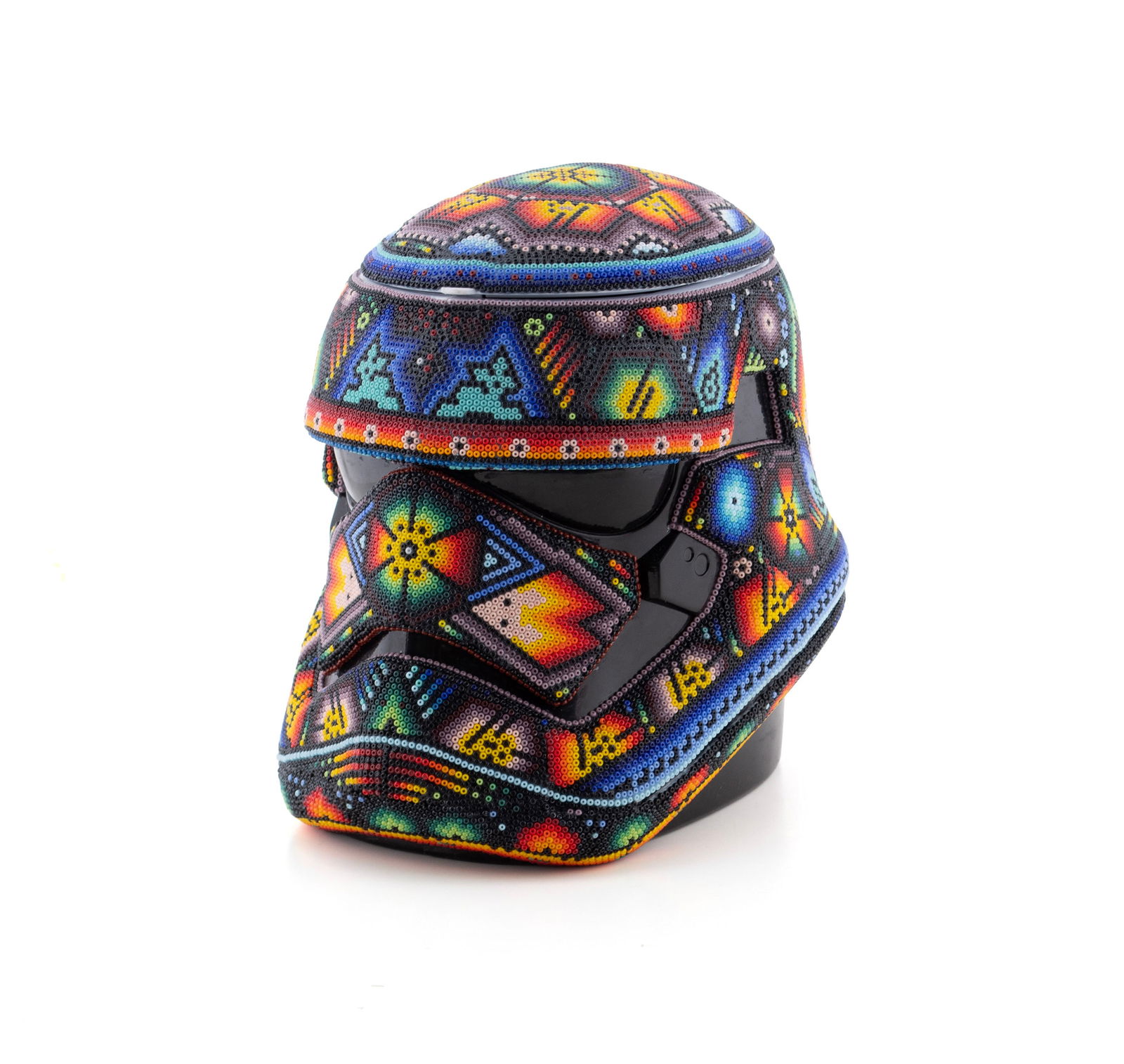 RICK WOLFRYD (AKA CHROMA) (AMERICAN, B. 1953): Rick Wolfryd (aka Chroma) American, b. 1953 Storm Trooper Helmet Colored glass beaded resin Signed, titled, dated 2025 with "TP .0005" on underside. Huichol style bead work figure. 8 x 7 x 9 1/2 in.