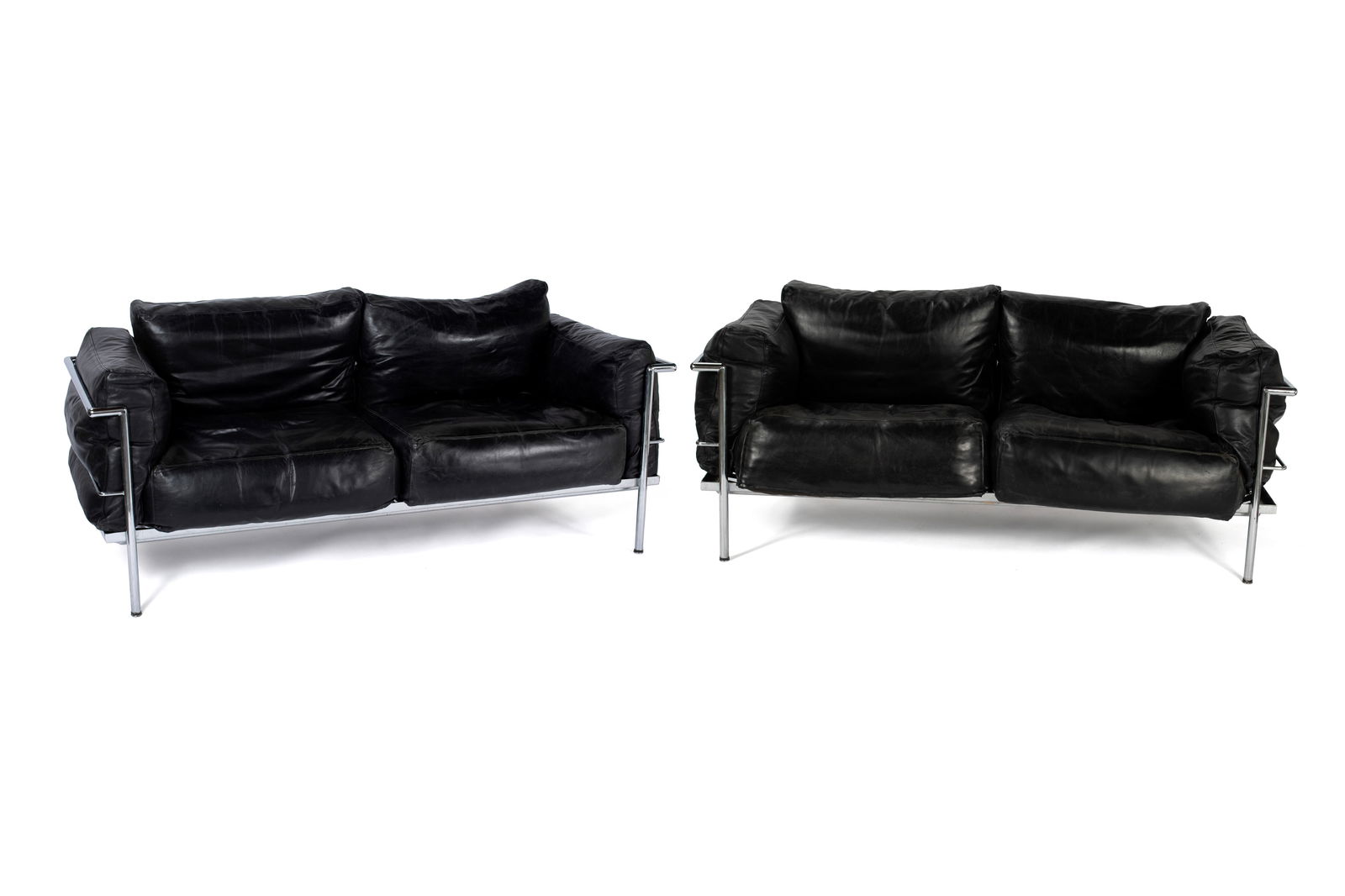 PAIR OF LE CORBUSIER LC2 TWO-SEATER SOFAS: PAIR OF LE CORBUSIER LC2 TWO-SEATER SOFAS Italian, 20th century. Black leather cushions on the chrome frames. 29 x 67 x 31 in. (73.7 x 170.2 x 78.7 cm.)