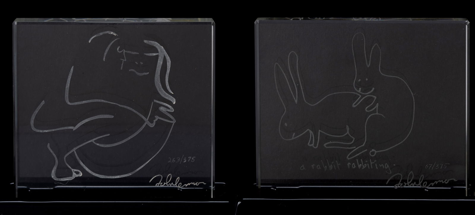 TWO JOHN LENNON ETCHED GLASS PLAQUES: TWO JOHN LENNON ETCHED GLASS PLAQUES Both with etched signatures and numbered 67/375 & 263/375. Glass on acrylic bases, in original boxes. Plaque on base: 5 x 5 3/4 x 1 5/8 in. (12.7 x 14.6 x 4.1