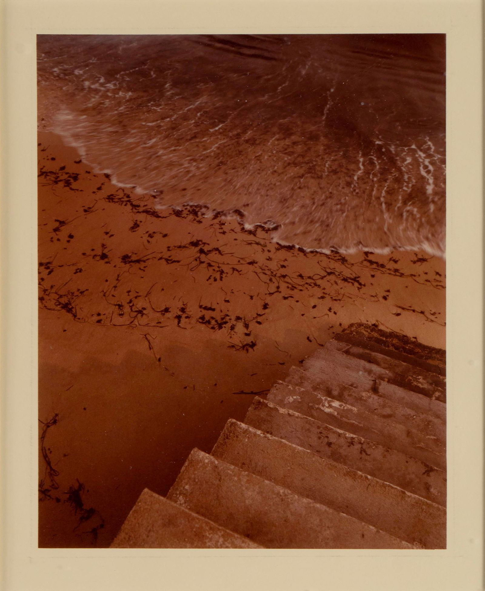 JOEL MEYEROWITZ (AMERICAN, B. 1938): Joel MeyerowitzAmerican, b. 1938The StepsPhotographSigned and dated 1977 to verso with additional notations. Image of a concrete staircase leading down to a beach, framed.Image: 9 1/2 x 7 1/2 in. (24