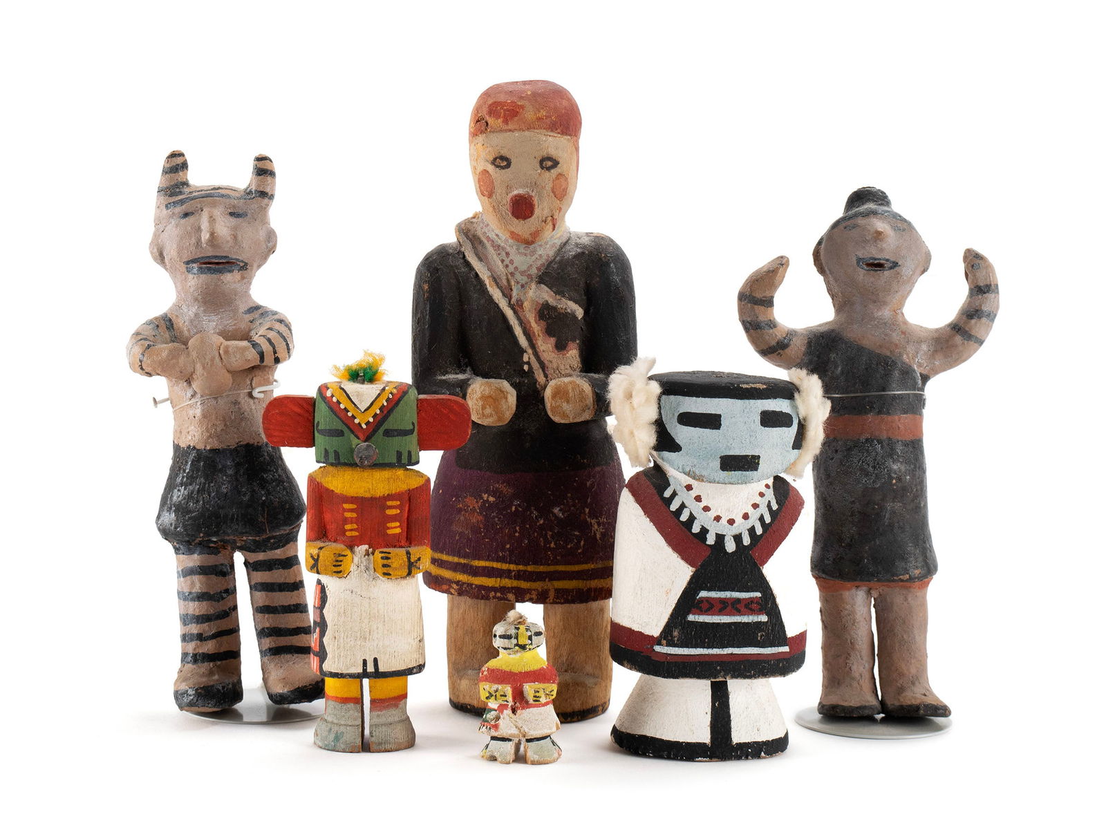 SIX HOPI KACHINA DOLLS: SIX HOPI KACHINA DOLLS Arizona, 20th century. Four (4) polychrome decorated carved cottonwood kachinas consisting of a Navajo woman, Hahai'i Wuhti, Route 66 style, a diminutive doll, possibly Tepp