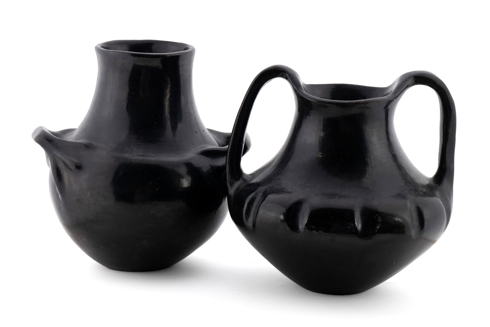 TWO BLACKWARE DOUBLE-HANDLED JARS ATTRIBUTED TO SANTA CLARA PUEBLO: TWO BLACKWARE DOUBLE-HANDLED JARS ATTRIBUTED TO SANTA CLARA PUEBLO First half 20th century. Two (2) unsigned blackware vessels having impressed decoration. 10 1/4 x 10 in. (26 x 25.4 cm.), 9 1/2 x 10