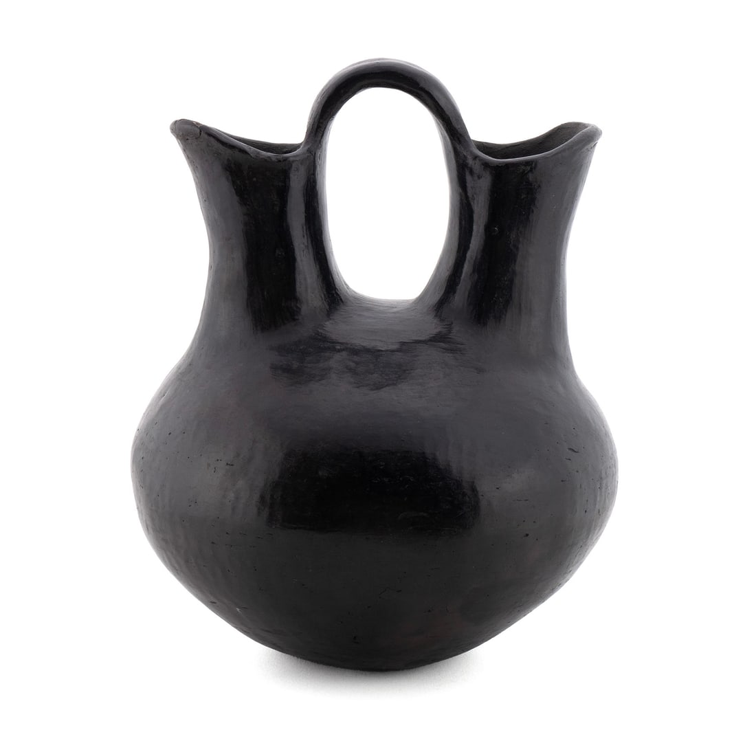 SANTA CLARA PUEBLO BLACKWARE WEDDING VASE: SANTA CLARA PUEBLO BLACKWARE WEDDING VASE 2nd Quarter 20th century. Polished hand-coiled single handled double spout vase having Fred Harvey style "From the Pueblo of Santa Clara" label. 10 1/2 x 8