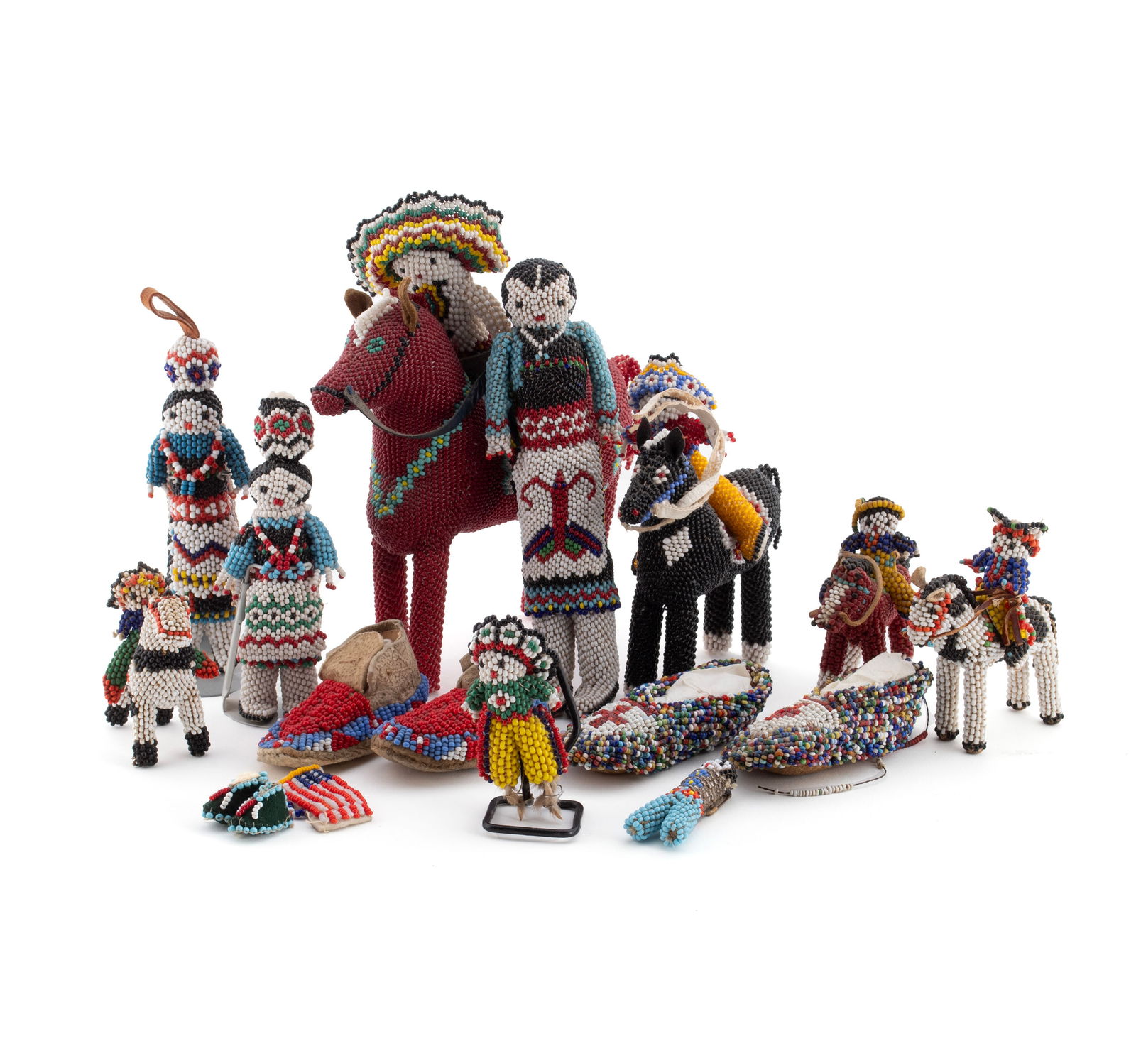 ZUNI BEADED DOLLS AND MINIATURE MOCCASINS: ZUNI BEADED DOLLS AND MINIATURE MOCCASINSNew Mexico, mid-20th century. Collection of thirteen (13) beaded items consisting of five (5) horse and rider figures, five (5) standing figures, two (2) pair