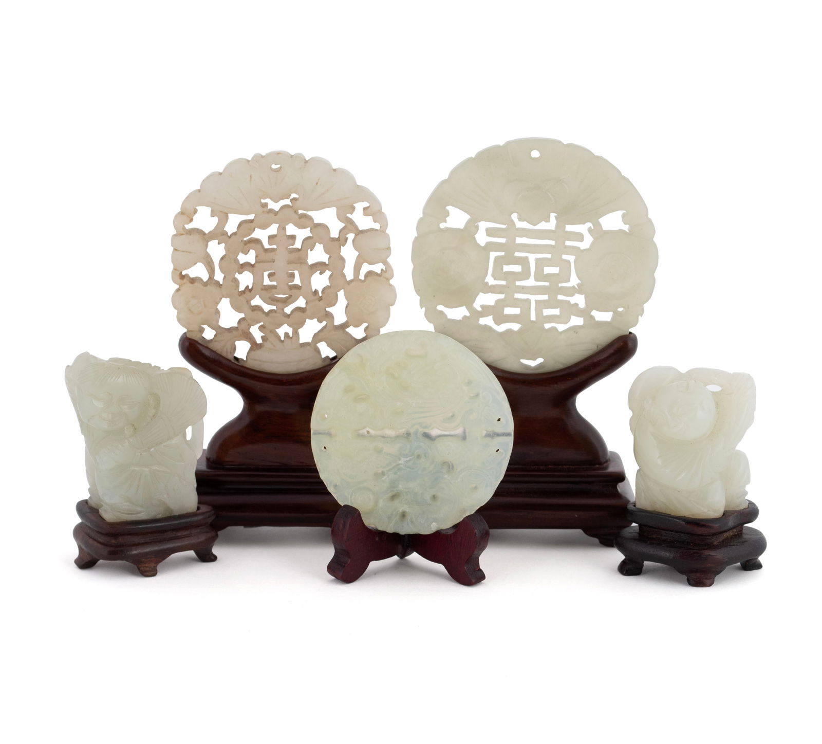 FIVE JADE CARVINGS: FIVE JADE CARVINGSChinese, 19th/20th century. Two figures on stands, and three pierced carved discs bearing a bat, a butterfly, and one with phoenix and dragon. Accompanied by stands.Largest amulet: 2