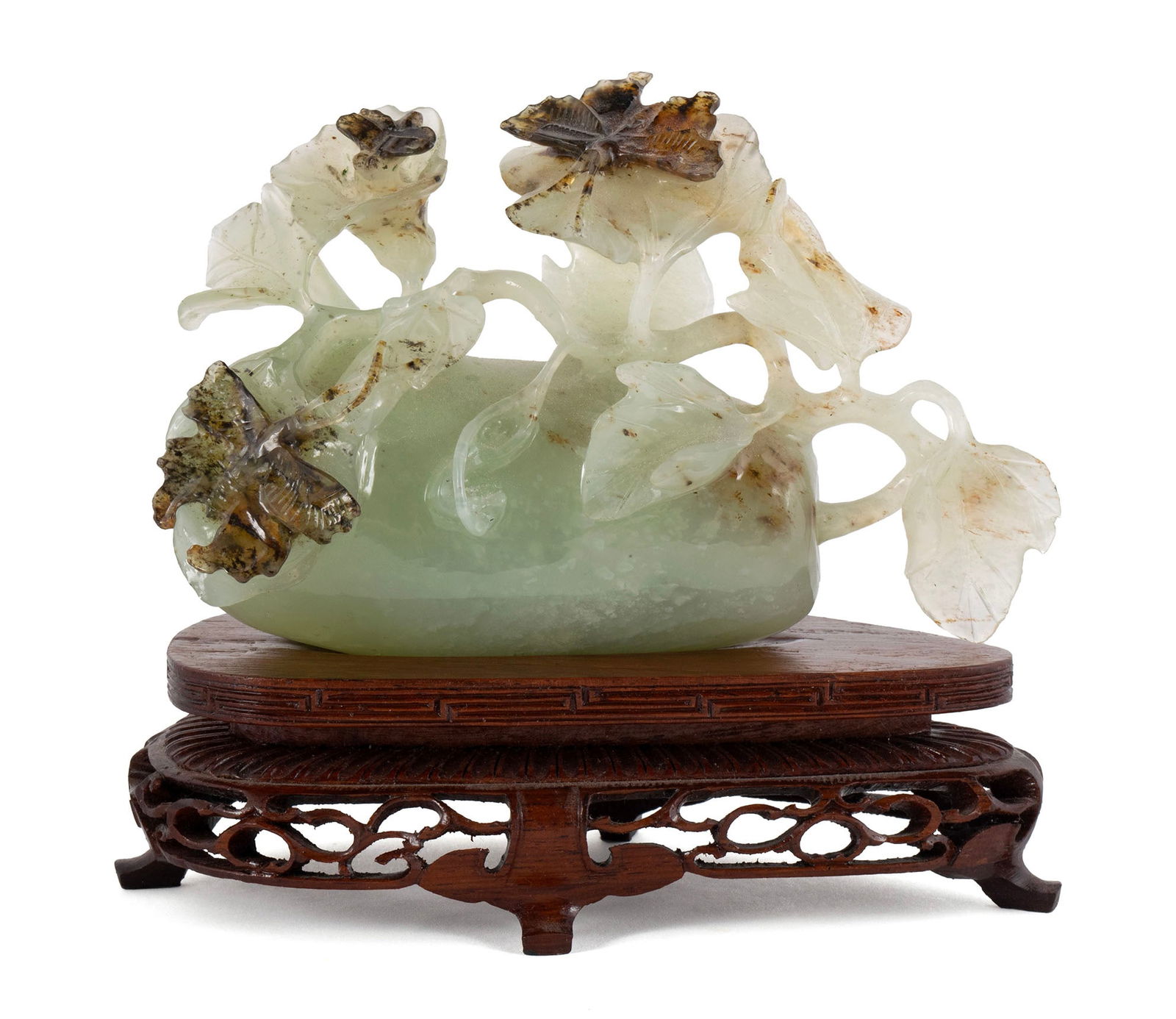 CHINESE JADE MELON WITH BUTTERFLIES: CHINESE JADE MELON WITH BUTTERFLIES Chinese, early 20th century. Jade carving with wooden stand. 5 1/2 x 3 1/2 x 2 1/4 in. (14 x 8.9 x 5.7 cm.)