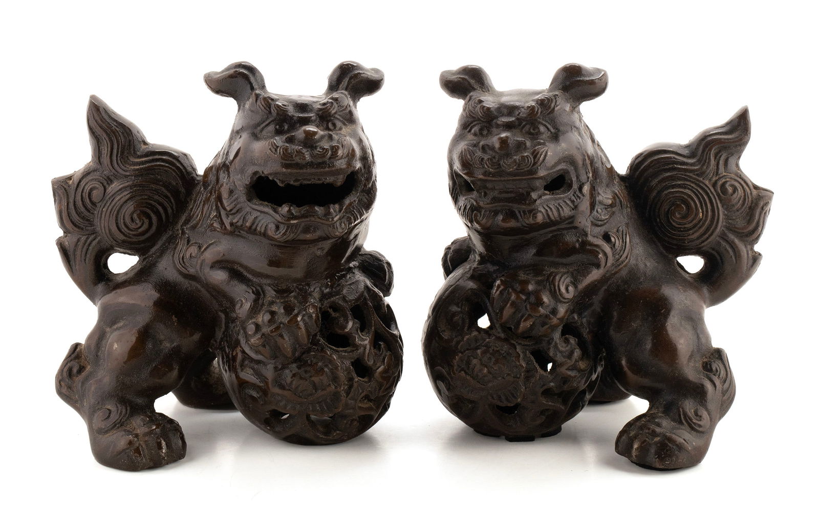 PAIR OF CAST IRON FOO DOGS: PAIR OF CAST IRON FOO DOGSChinese, 20th century. Pair of foo dogs with faux bronze finish.7 x 6 1/2 x 5 in. (17.8 x 16.5 x 12.7 cm.)
