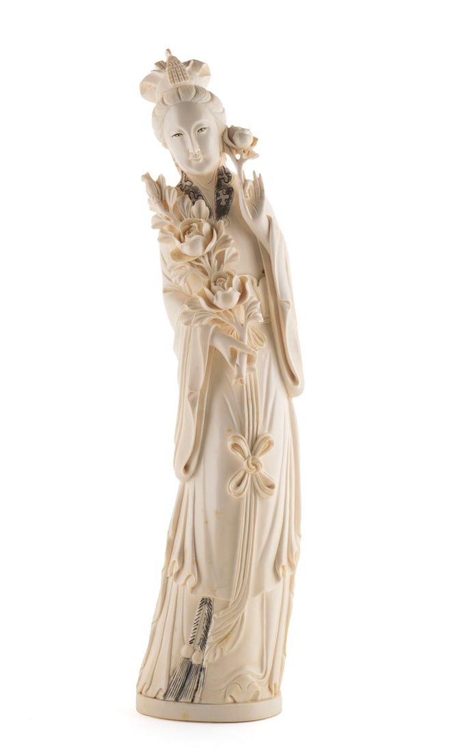 CHINESE CARVED FIGURE OF GUANYIN: CHINESE CARVED FIGURE OF GUANYINEarly 20th century. Standing Guanyin holding flowers, marked underfoot.13 3/4 in. (34.9 cm.)
