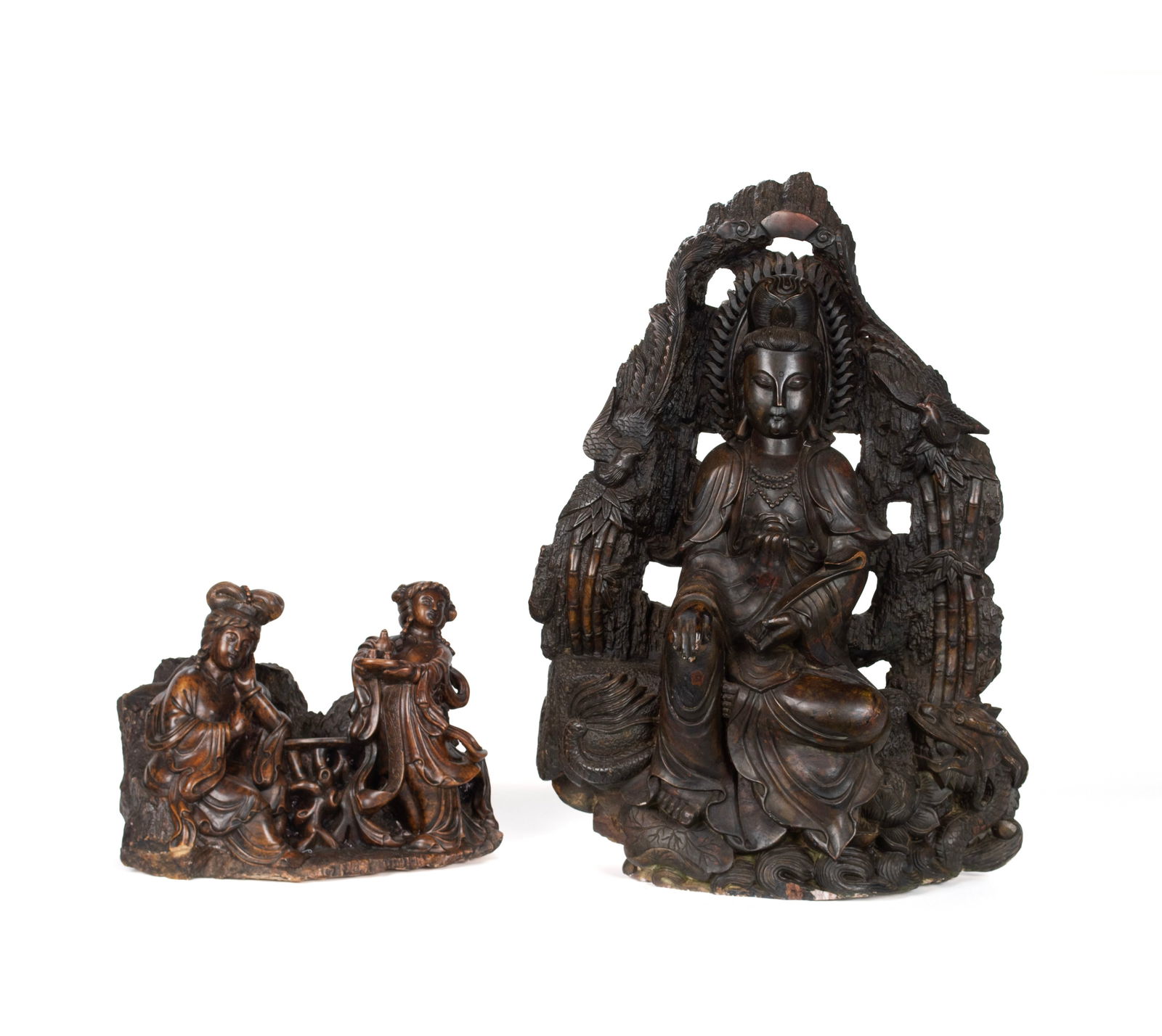 TWO QUAN YIN FIGURE GROUPS: TWO QUAN YIN FIGURE GROUPSChinese, 20th century, carved and brown stained stone. One a large seated figure holding a scepter, flanked by phoenix birds and a dragon below. The other showing two women a