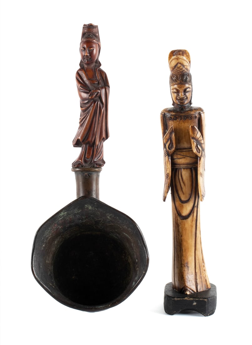 TWO CHINESE CARVED FIGURES: TWO CHINESE CARVED FIGURES20th century. Carved wood standing Guanyin handled silk iron together with a carved bone standing figure of a woman.Iron: 12 1/2 in. (31.8 cm.), Bone: 11 in. (27.9 cm.) heigh