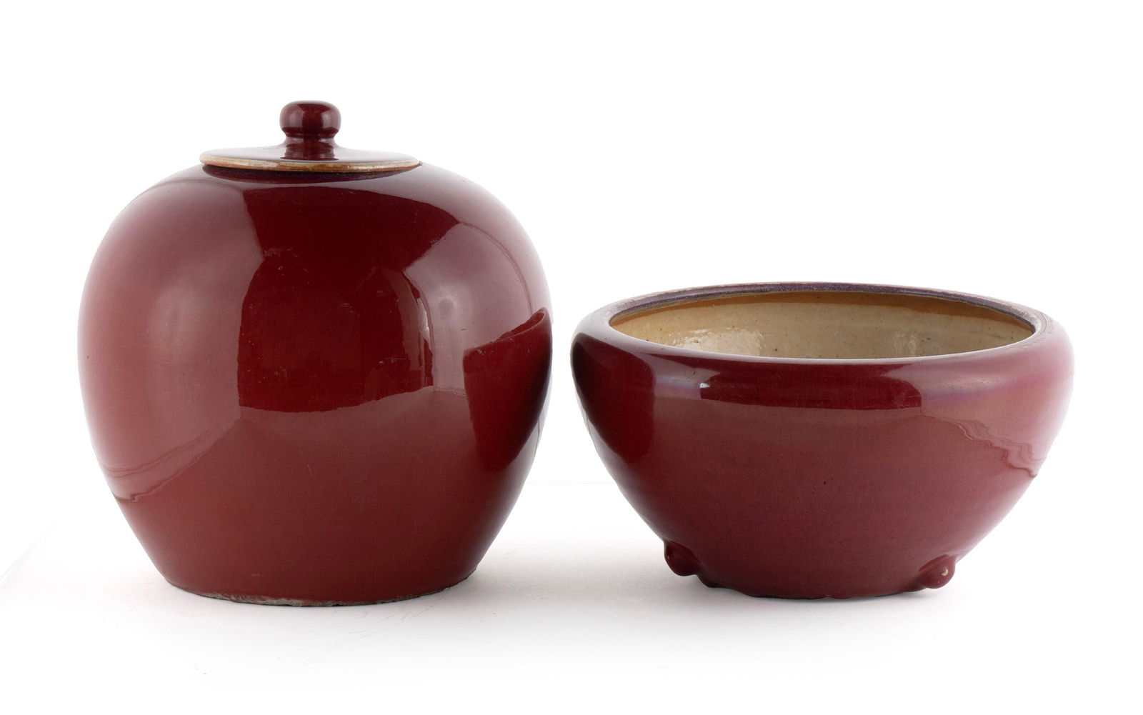 TWO SANG DE BOEUF VESSELS: TWO SANG DE BOEUF VESSELS Chinese, 20th century, glazed porcelain. A tapering ovoid form bowl with inverted rim, sitting on three small lug feet. Along with an oxblood lidded ginger jar having