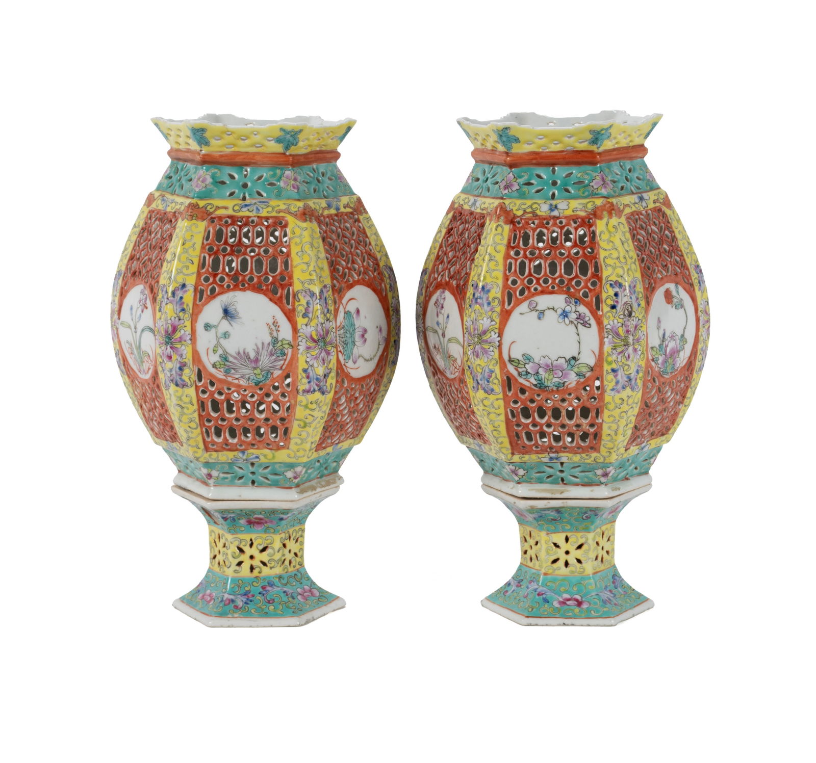 PAIR OF HEXAGONAL FAMILE ROSE LANTERNS: PAIR OF HEXAGONAL FAMILE ROSE LANTERNS Chinese, 20th century, porcelain. Reticulated throughout with flaring rims on top, resting on separate fitted bases. 12 x 6 x 7 in. (30.5 x 15.2 x 17.8 cm.)