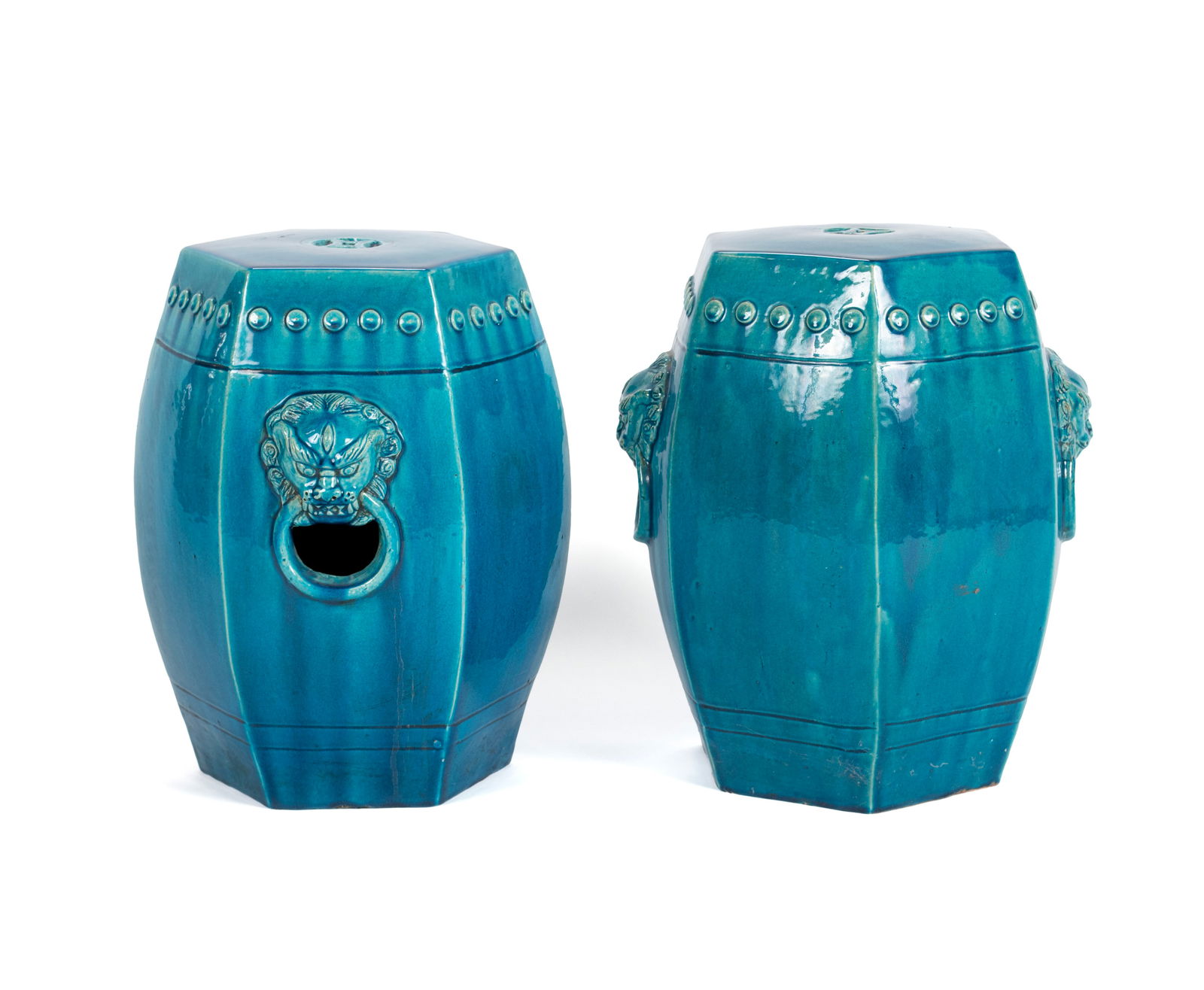PAIR OF CHINOISERIE TURQUOISE GLAZED GARDEN SEATS: PAIR OF CHINOISERIE TURQUOISE GLAZED GARDEN SEATSChinese, 20th century, ceramic. Hexagonal form with pierced seats and lion mask handles showing open ring designs in their mouth.18 x 15 x 14 in. (45.7