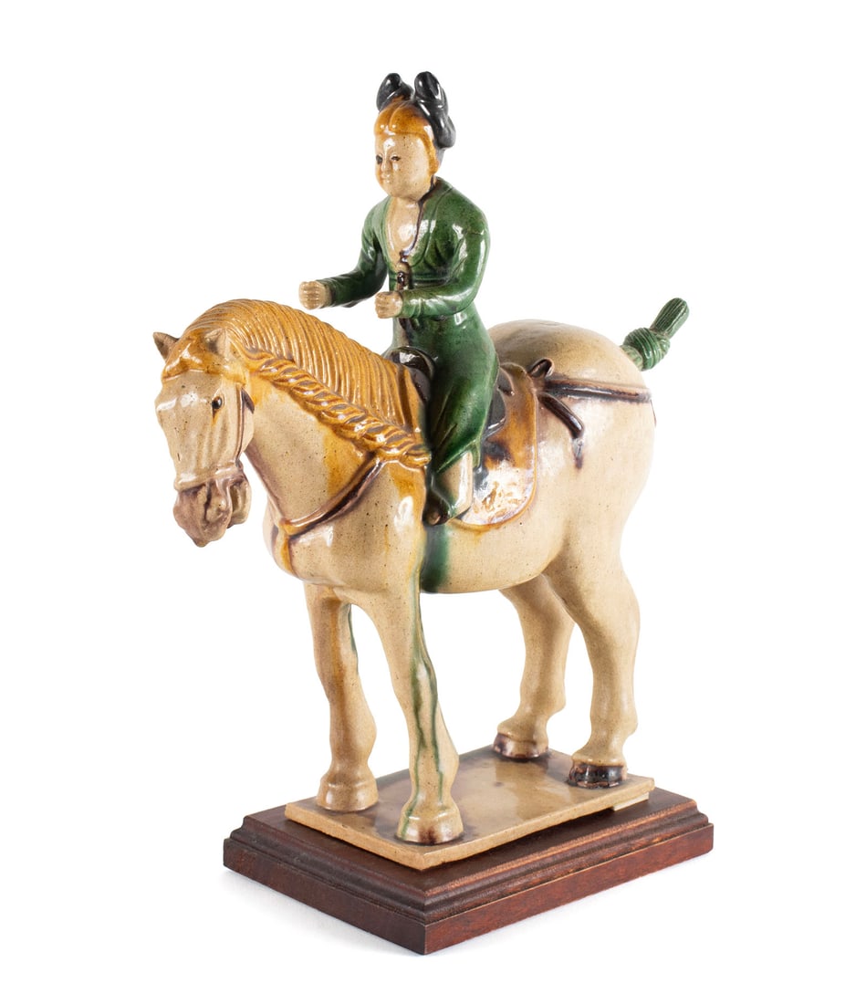 CHINESE TANG STYLE POTTERY HORSE AND RIDER: CHINESE TANG STYLE POTTERY HORSE AND RIDERSancai glazed pottery horse with female rider on rectangular base, the tail removable.13 x 3 1/2 x 12 in. (33 x 8.9 x 30.5 cm.)