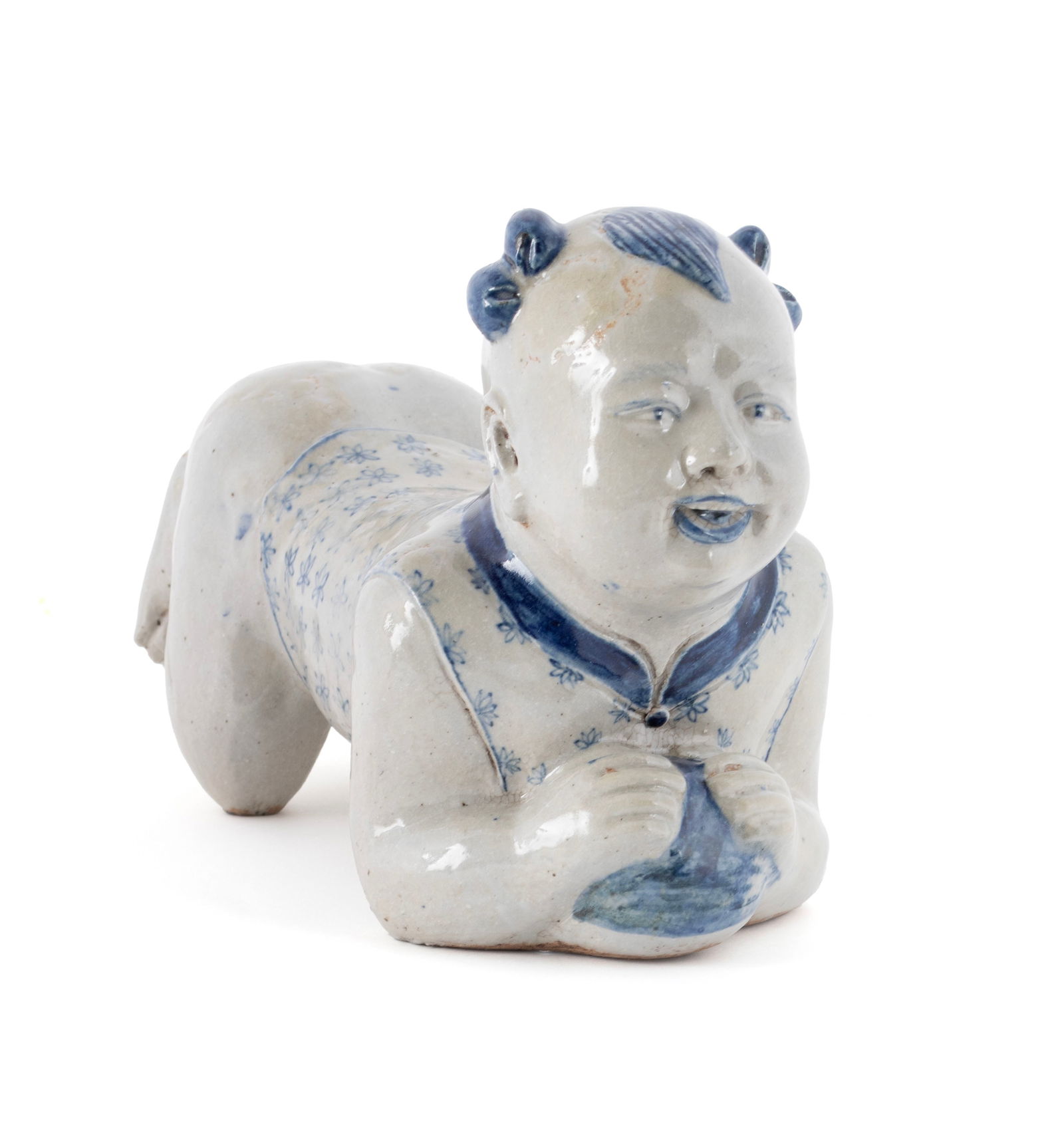 CHINESE BLUE AND WHITE PORCELAIN BOY-FORM PILLOW: CHINESE BLUE AND WHITE PORCELAIN BOY-FORM PILLOWFirst-half 20th century. Bue foliate decorated boy with ball.9 x 5 x 13 in. (22.9 x 12.7 x 33 cm.)