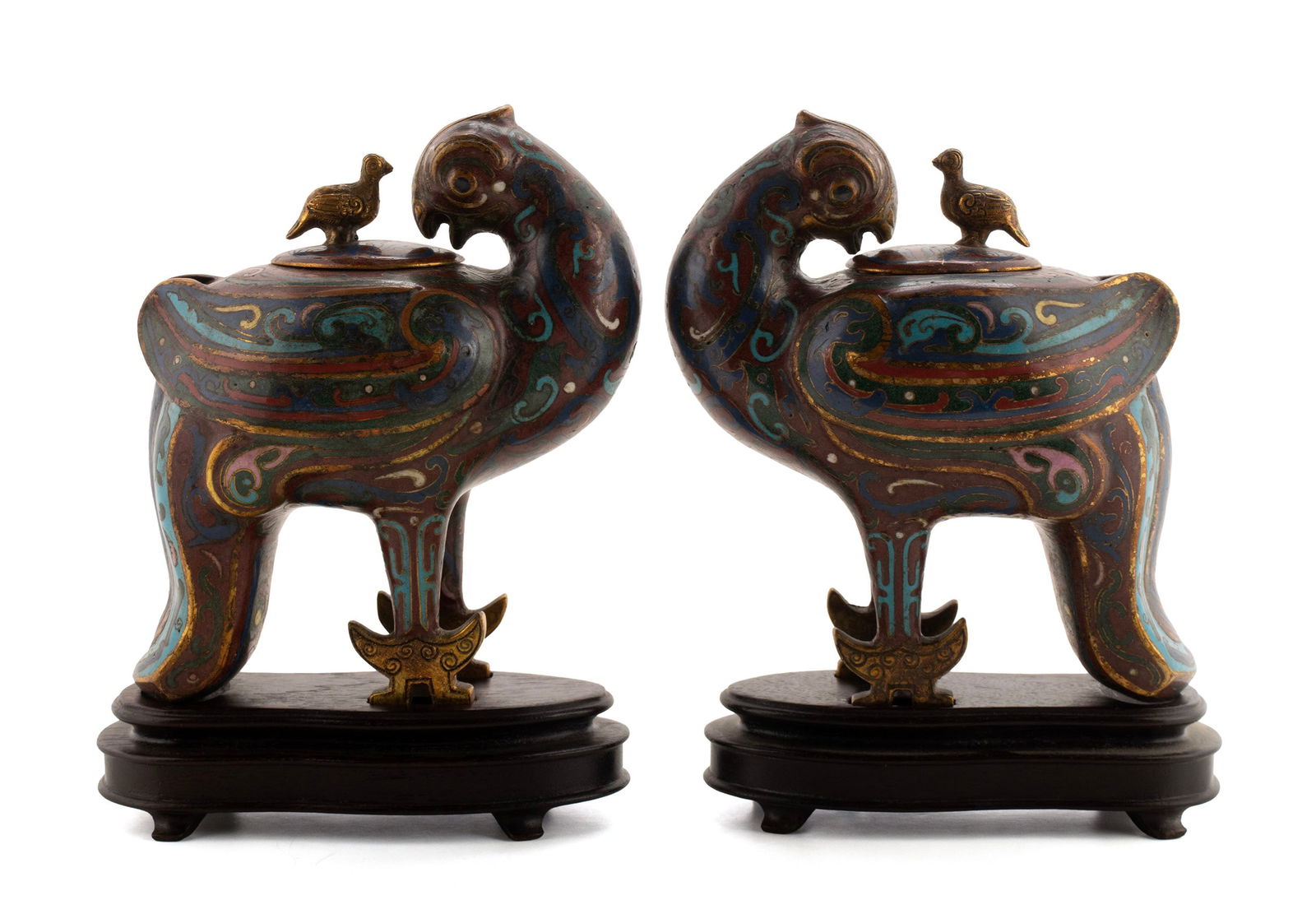 PAIR OF CLOISONNE BIRD INCENSE BURNERS: PAIR OF CLOISONNE BIRD INCENSE BURNERSChinese, late Qing. Cloisonne and gilt-bronze Song style bird-form censors on wooden stands.6 1/2 x 5 1/2 x 3 in. (16.5 x 14 x 7.6 cm.)