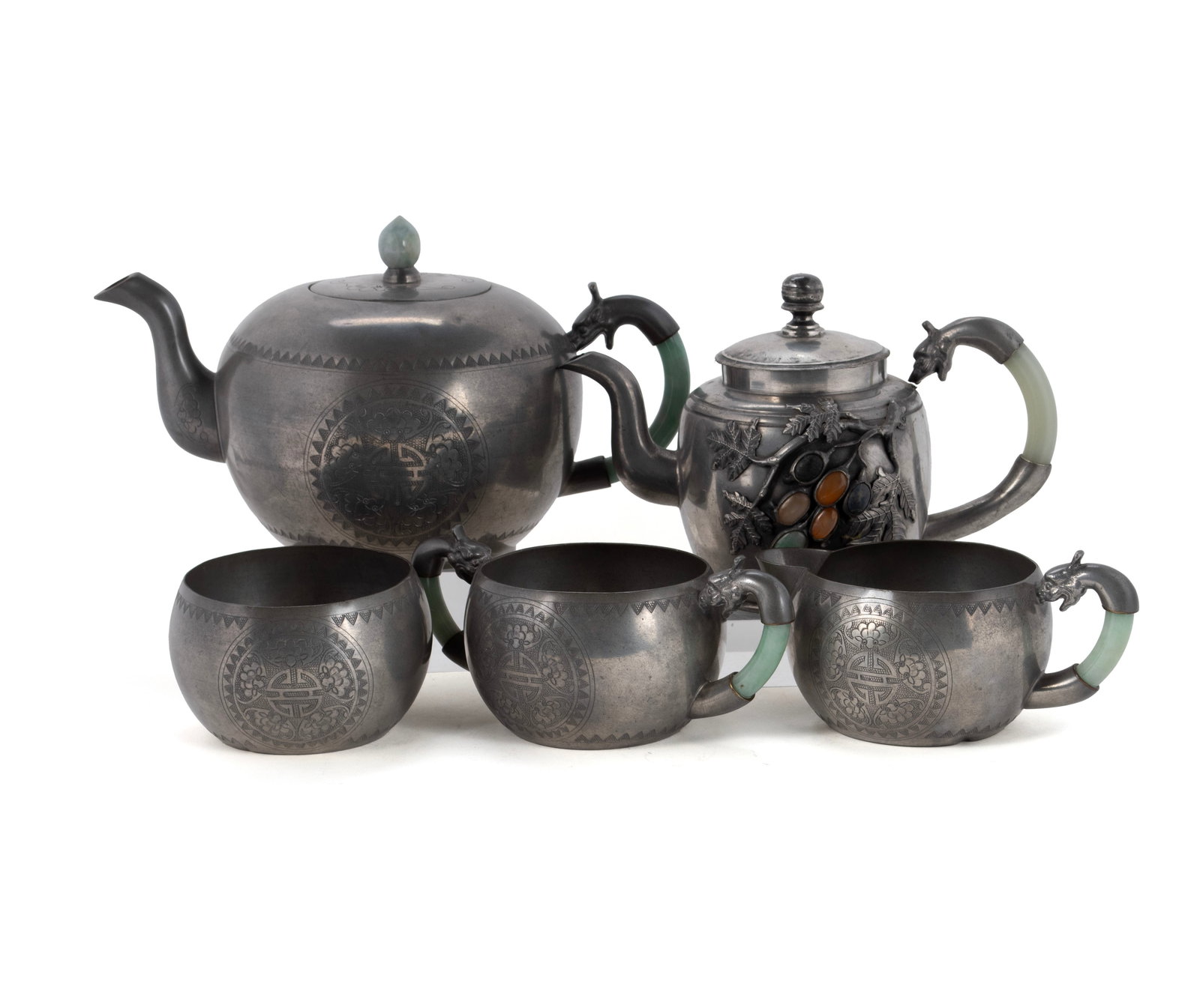 CHINESE PEWTER TEA SET: CHINESE PEWTER TEA SET 20th century. Four-piece pewter tea set with jade handles, and another tea pot with hardstone cabochon decoration. Largest: 5 1/4 x 8 3/4 x 5 in. (13.3 x 22.2 x 12.7 cm.)
